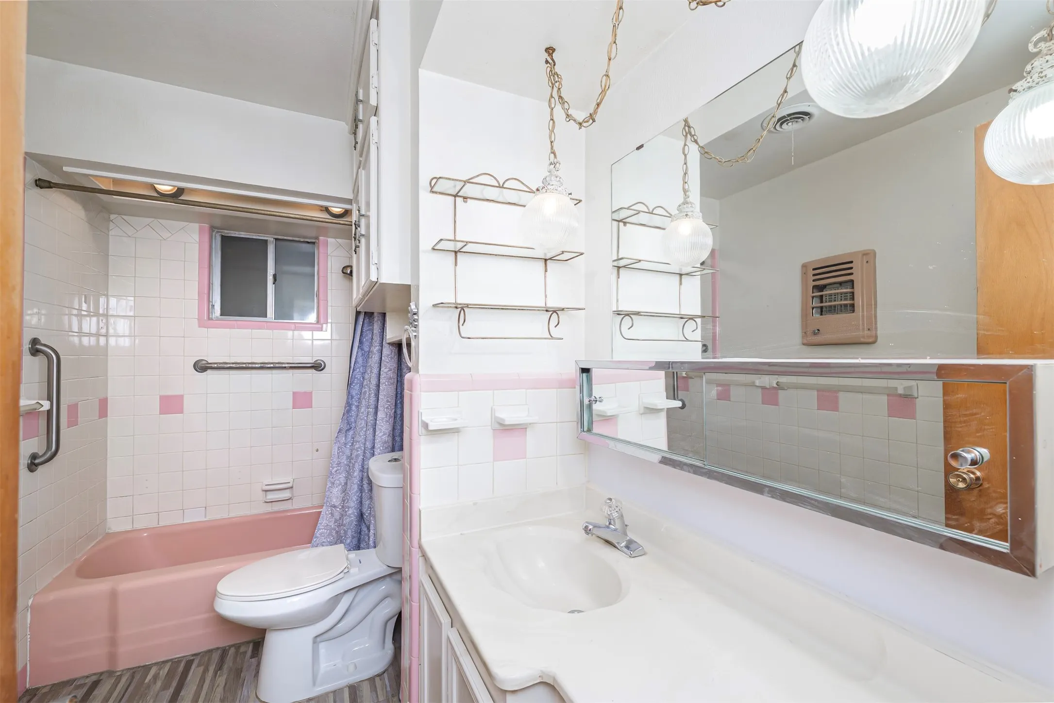 Full bathroom featuring vanity, shower / bath combo, and dark wood-style flooring