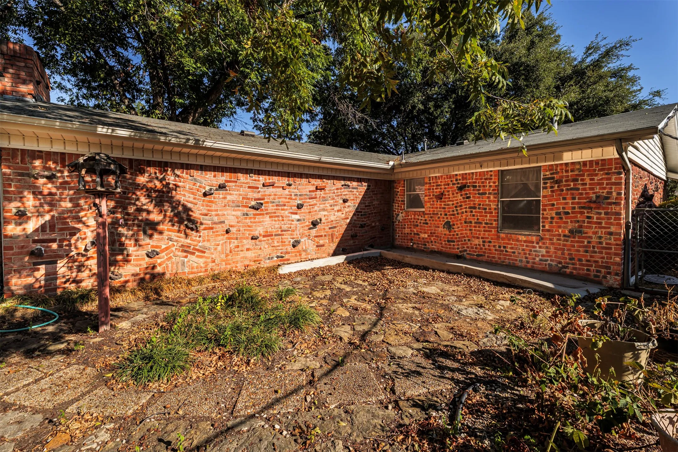 Rear view of house featuring brick siding