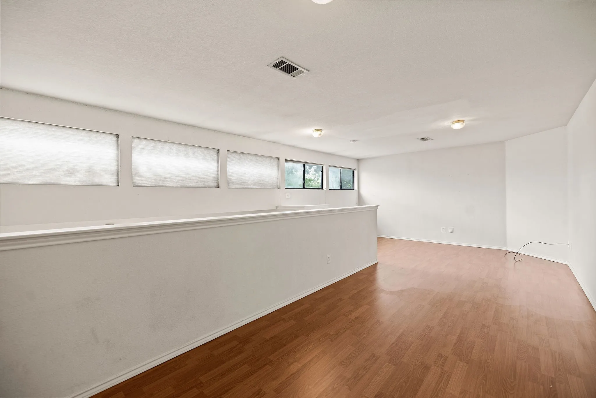 Empty room with wood finished floors and baseboards