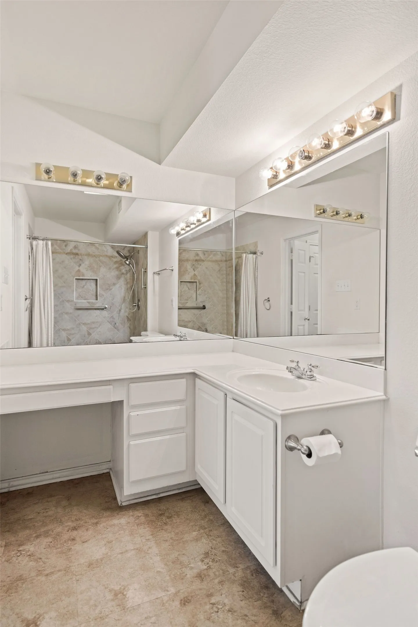 Full bathroom featuring toilet, vanity, and curtained shower