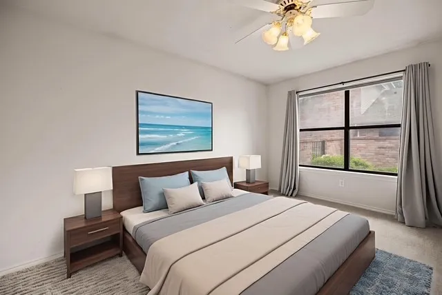 Bedroom with ceiling fan and carpet flooring