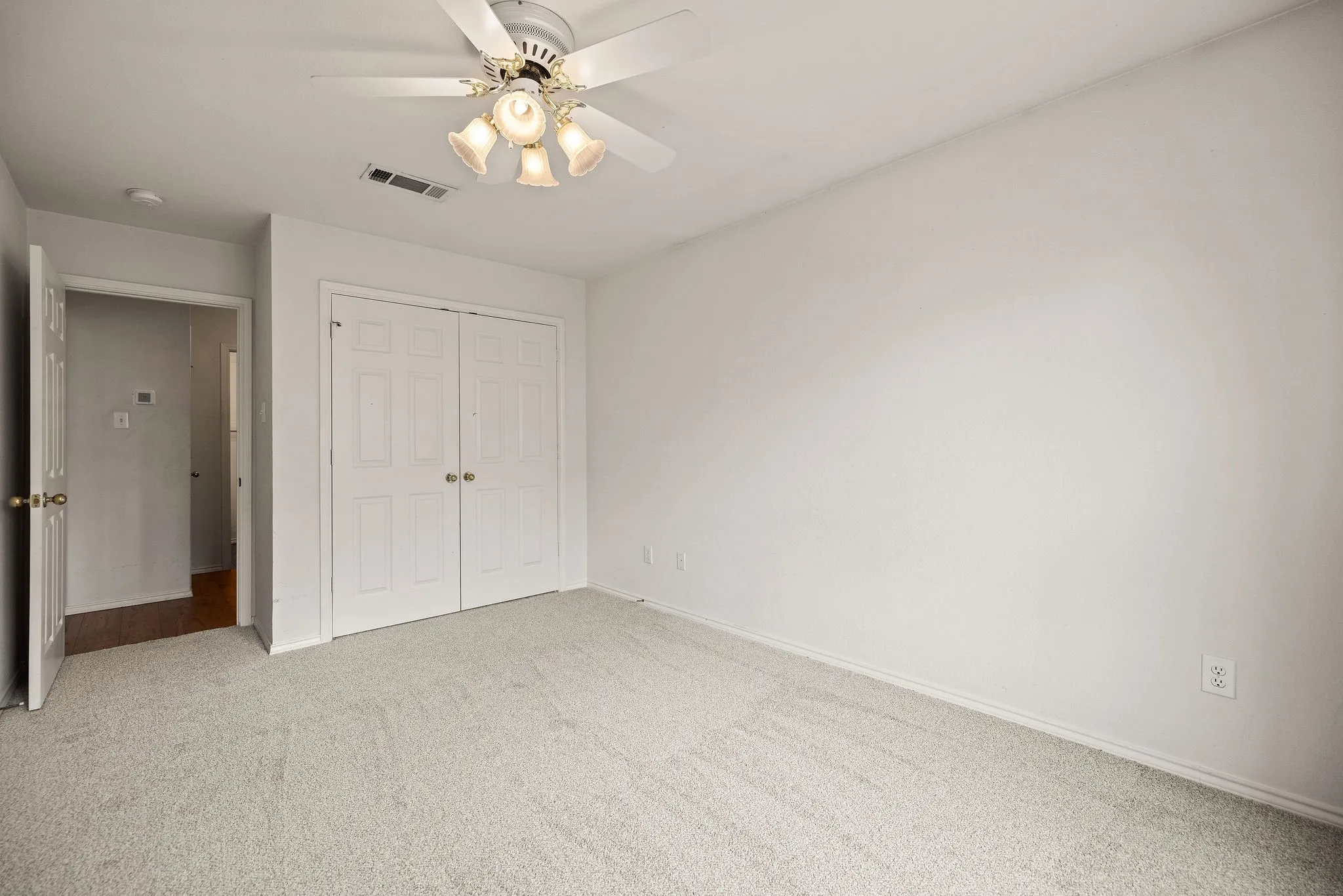 Unfurnished bedroom with a closet, carpet flooring, a ceiling fan, and baseboards