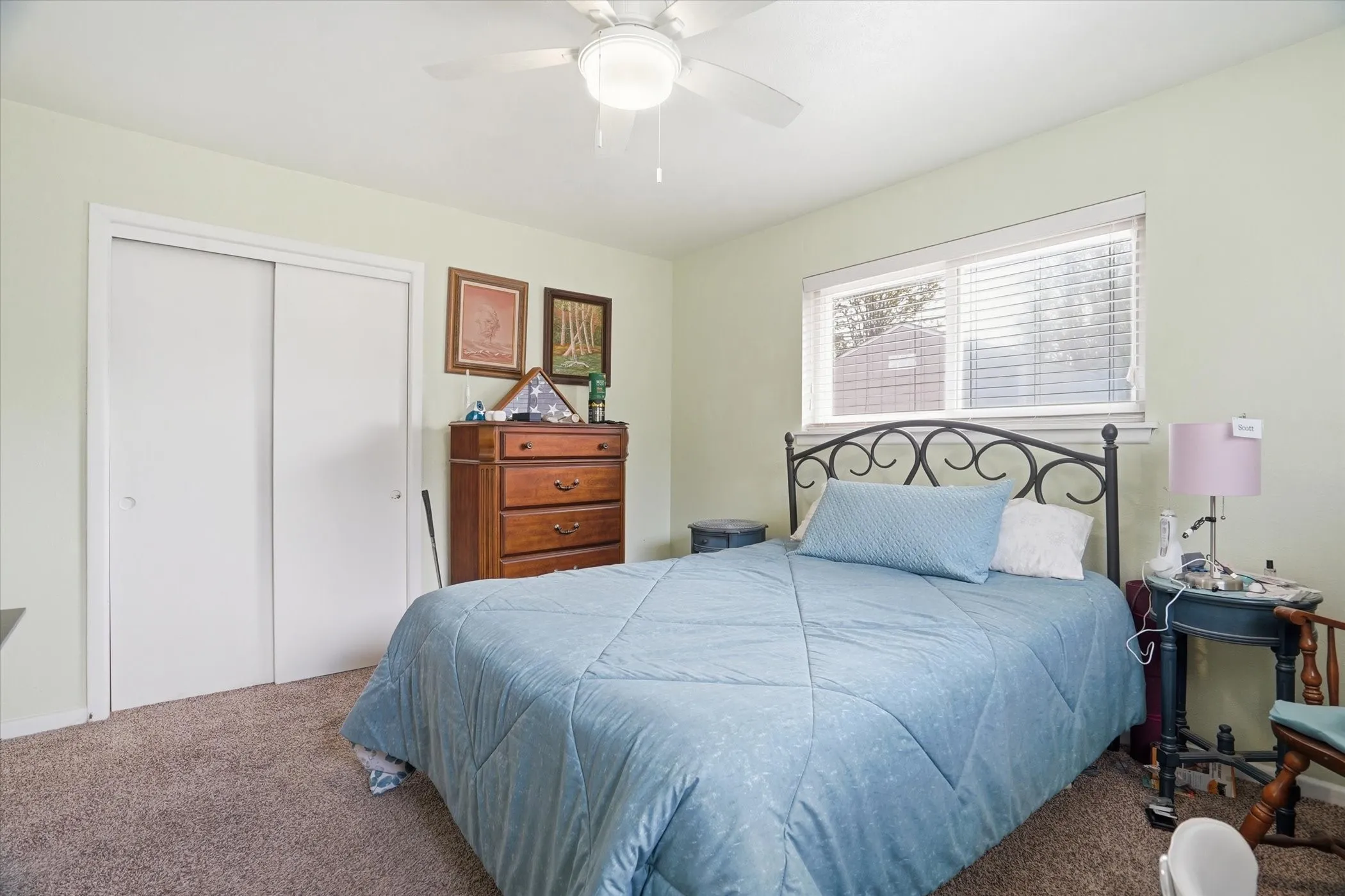 Bedroom with a closet, carpet, and a ceiling fan