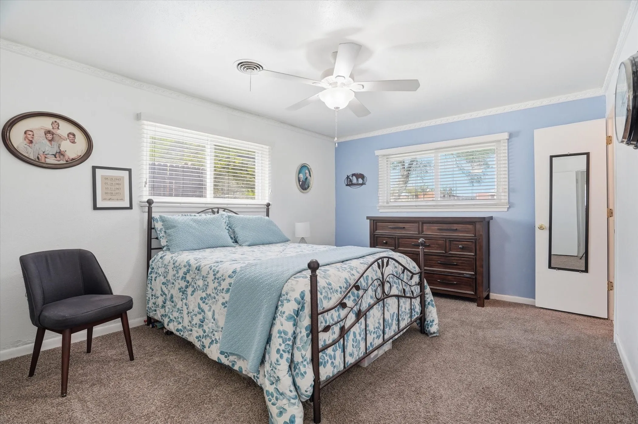 Carpeted bedroom with ornamental molding and a ceiling fan