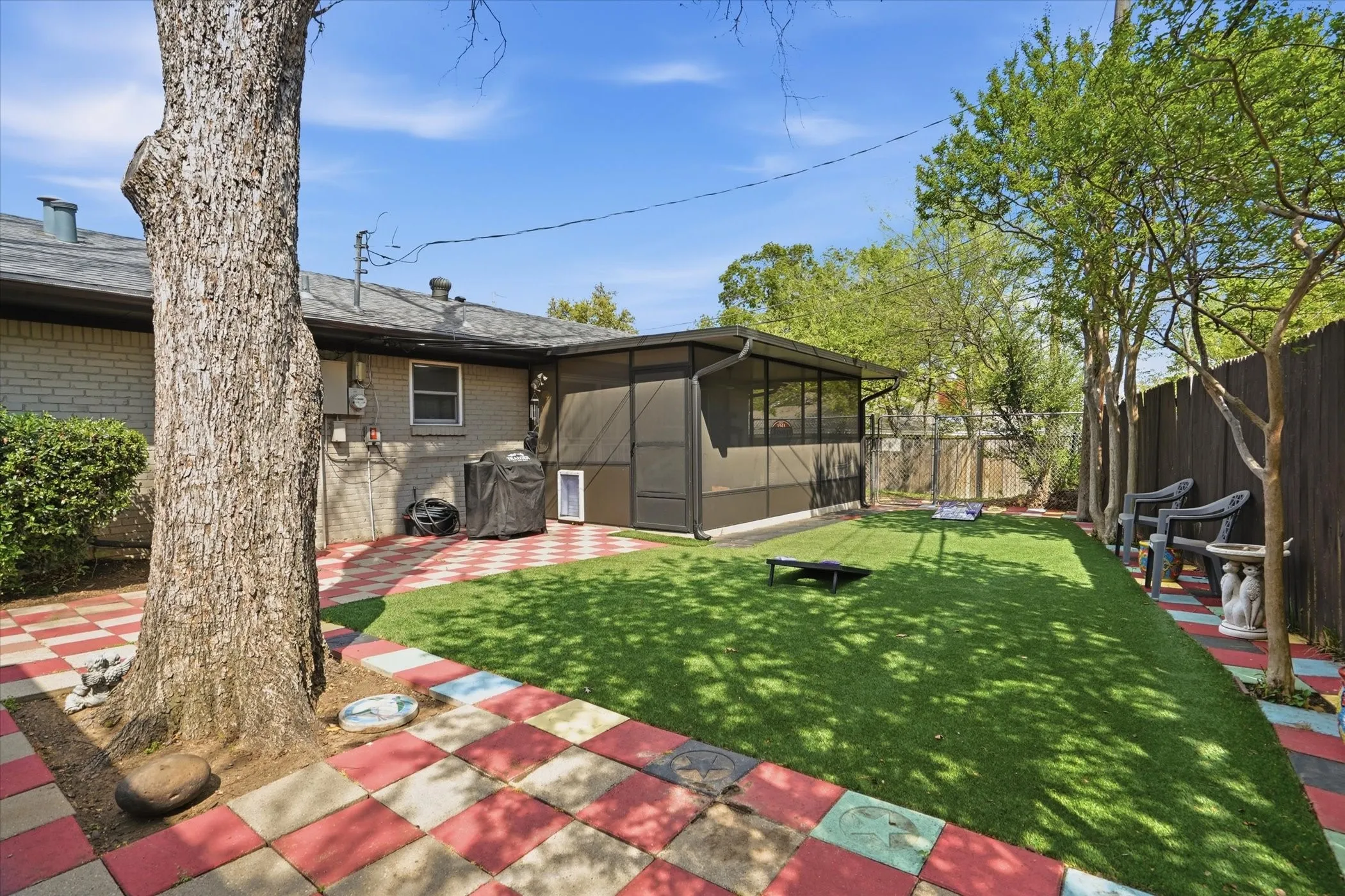 Fenced backyard featuring a patio area and a sunroom