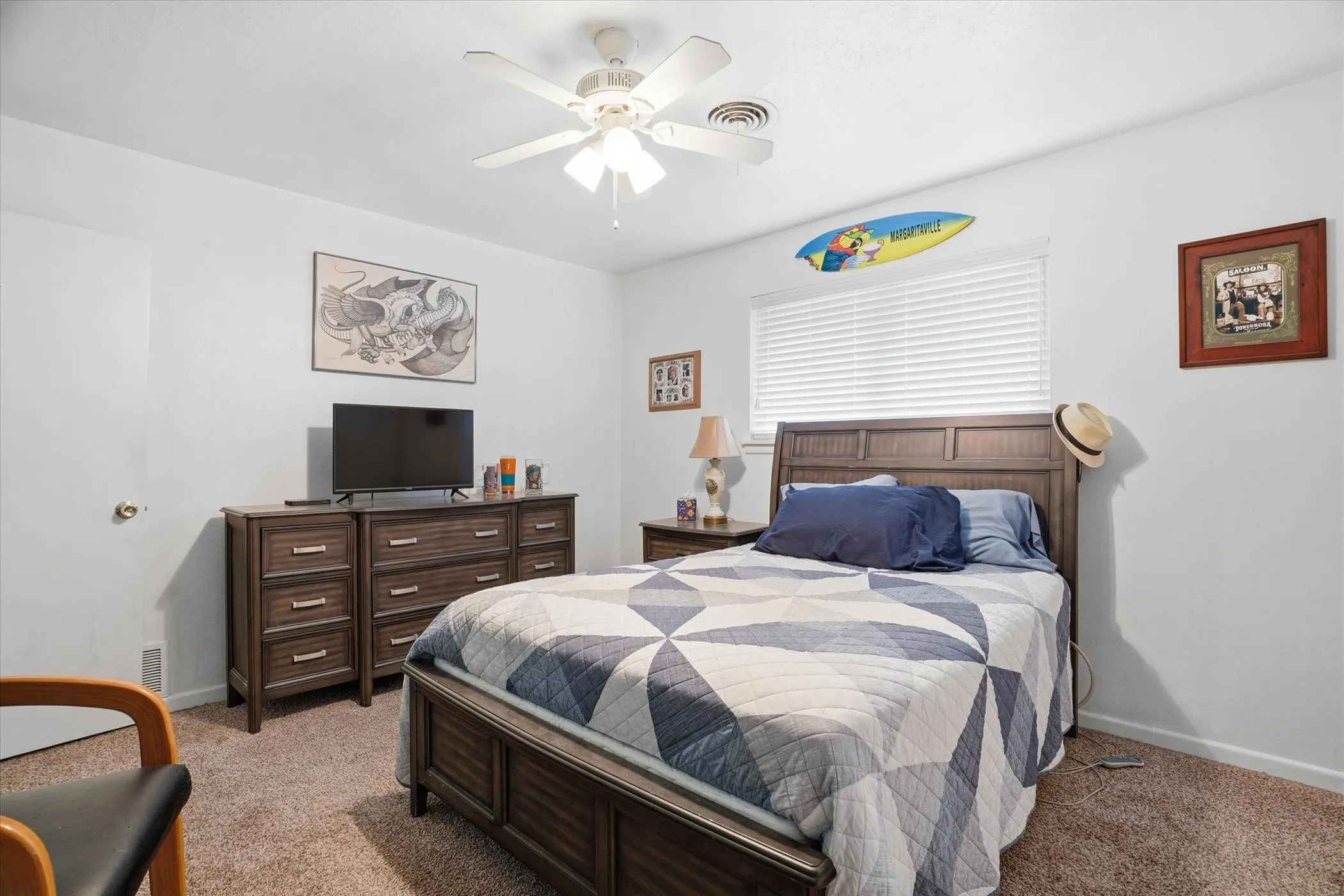 Carpeted bedroom featuring baseboards and a ceiling fan