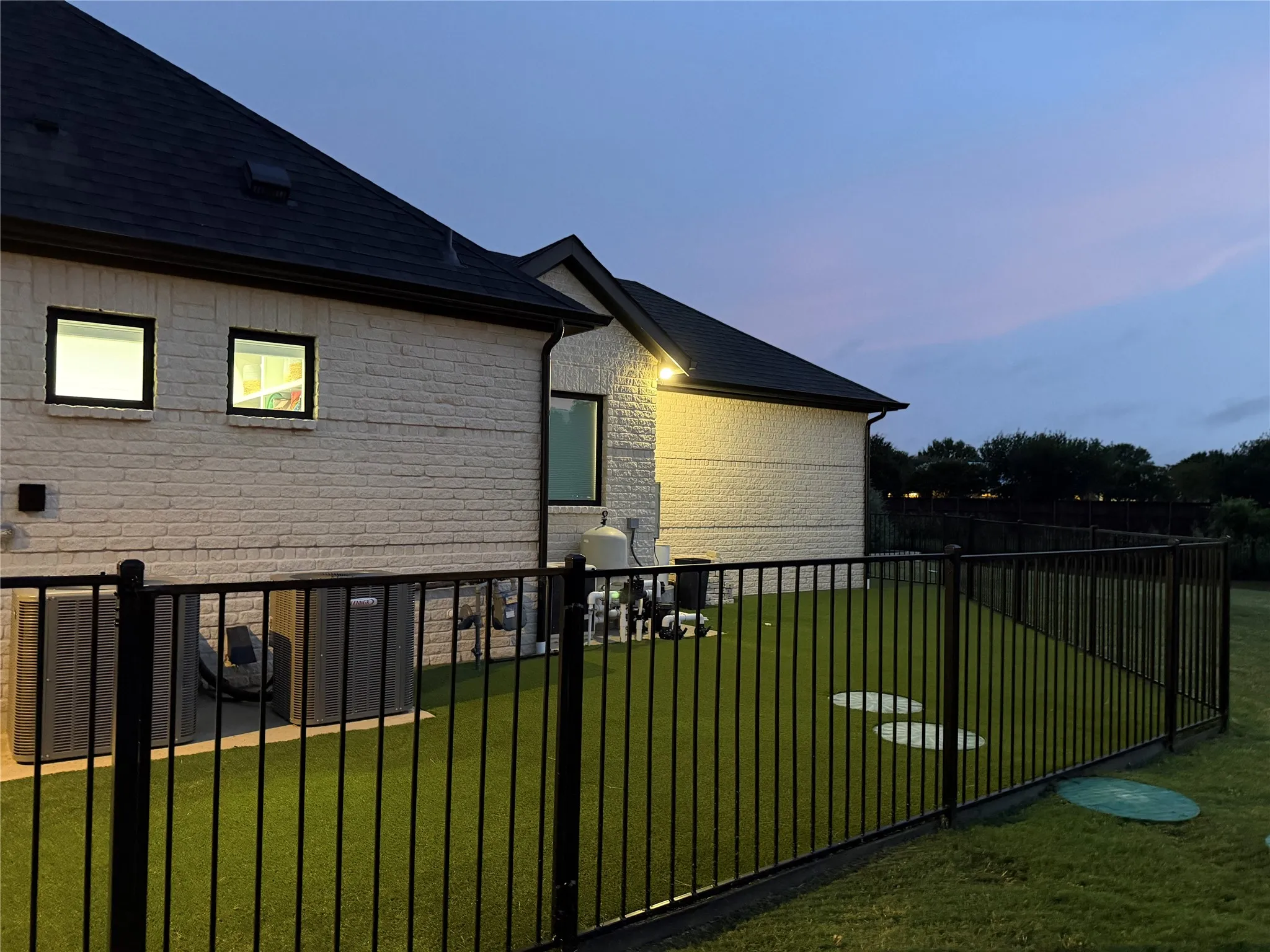Secure, turfed dog run has WiFi controlled door into laundry room.