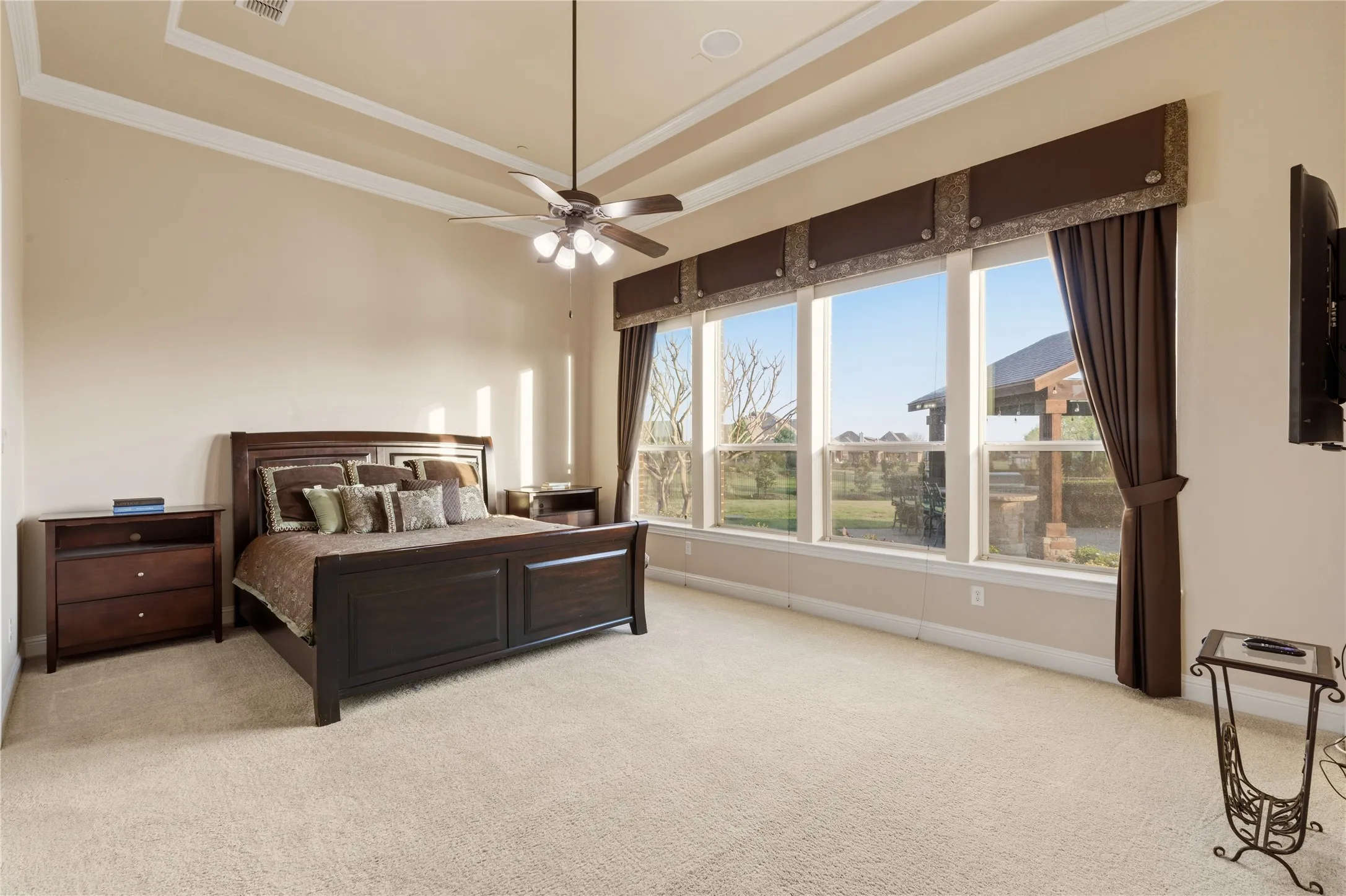 Primary Bedroom w/ views of backyard and pool area