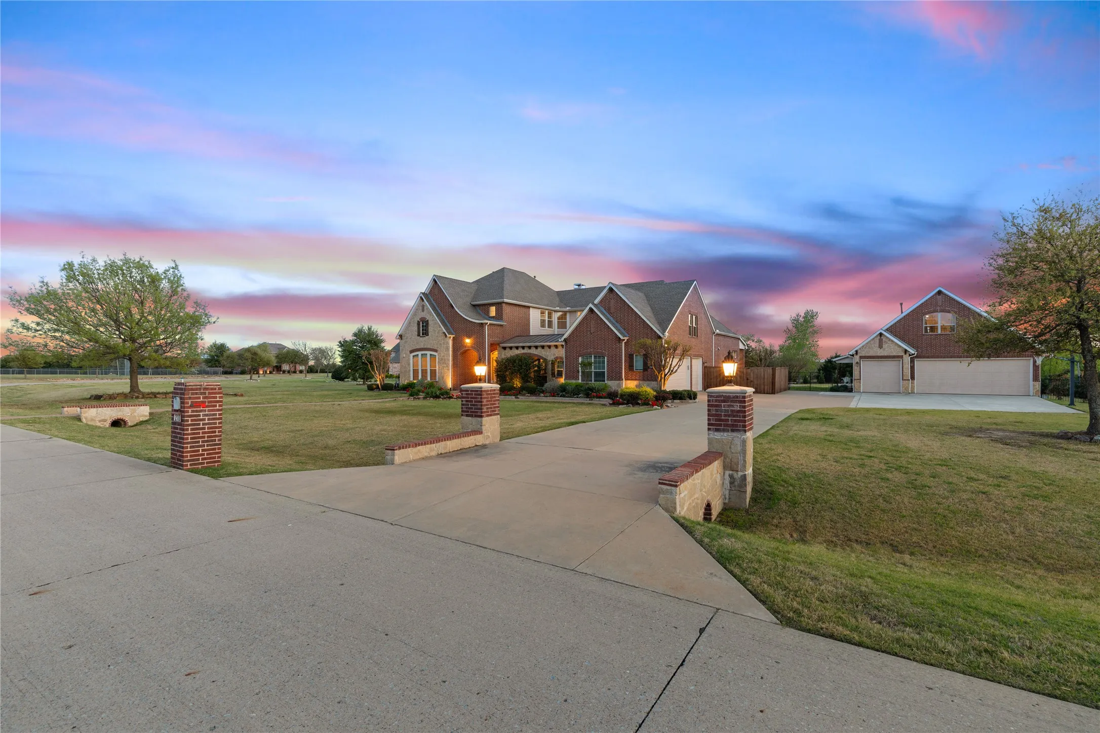 View of front of property featuring a lawn and concrete driveway