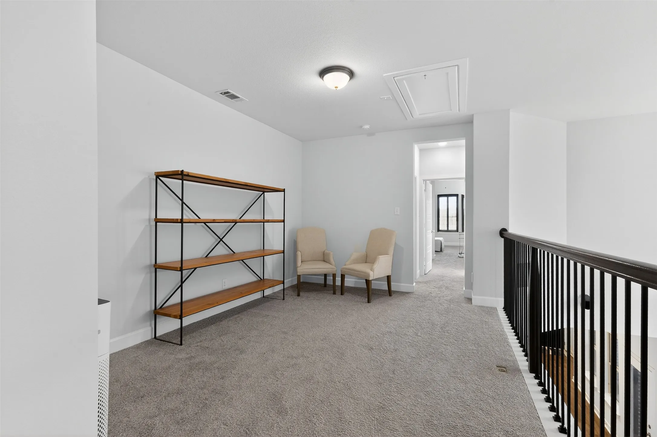 Hall featuring carpet and an upstairs landing