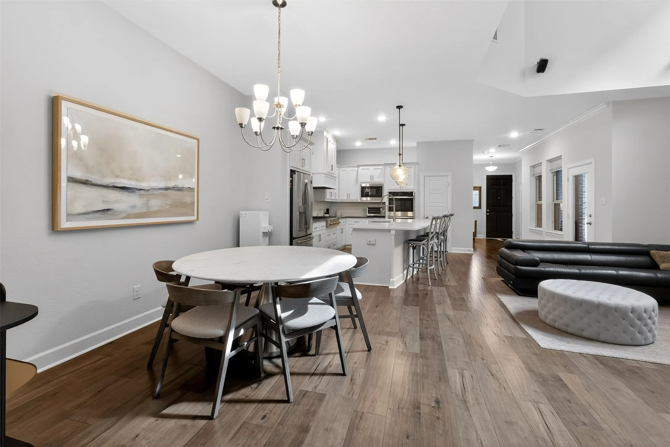 Dining space featuring dark wood-style floors and a chandelier