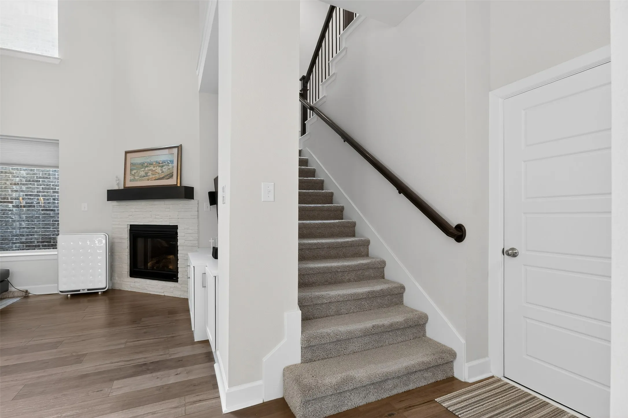 Mudroom with dark wood-style flooring and a textured wall