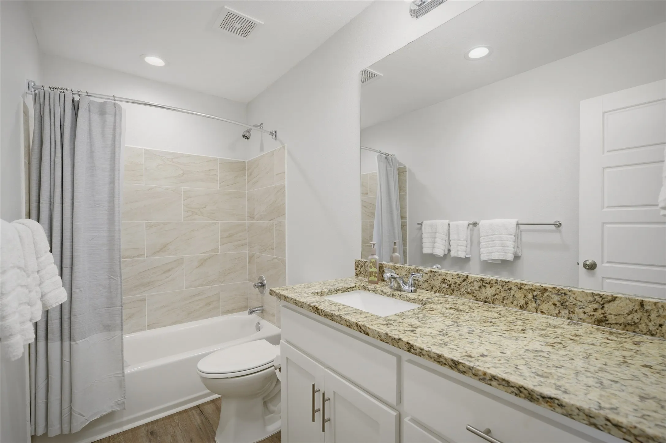 2nd full bath with granite countertops, bathtub/shower combination and a large vanity.
