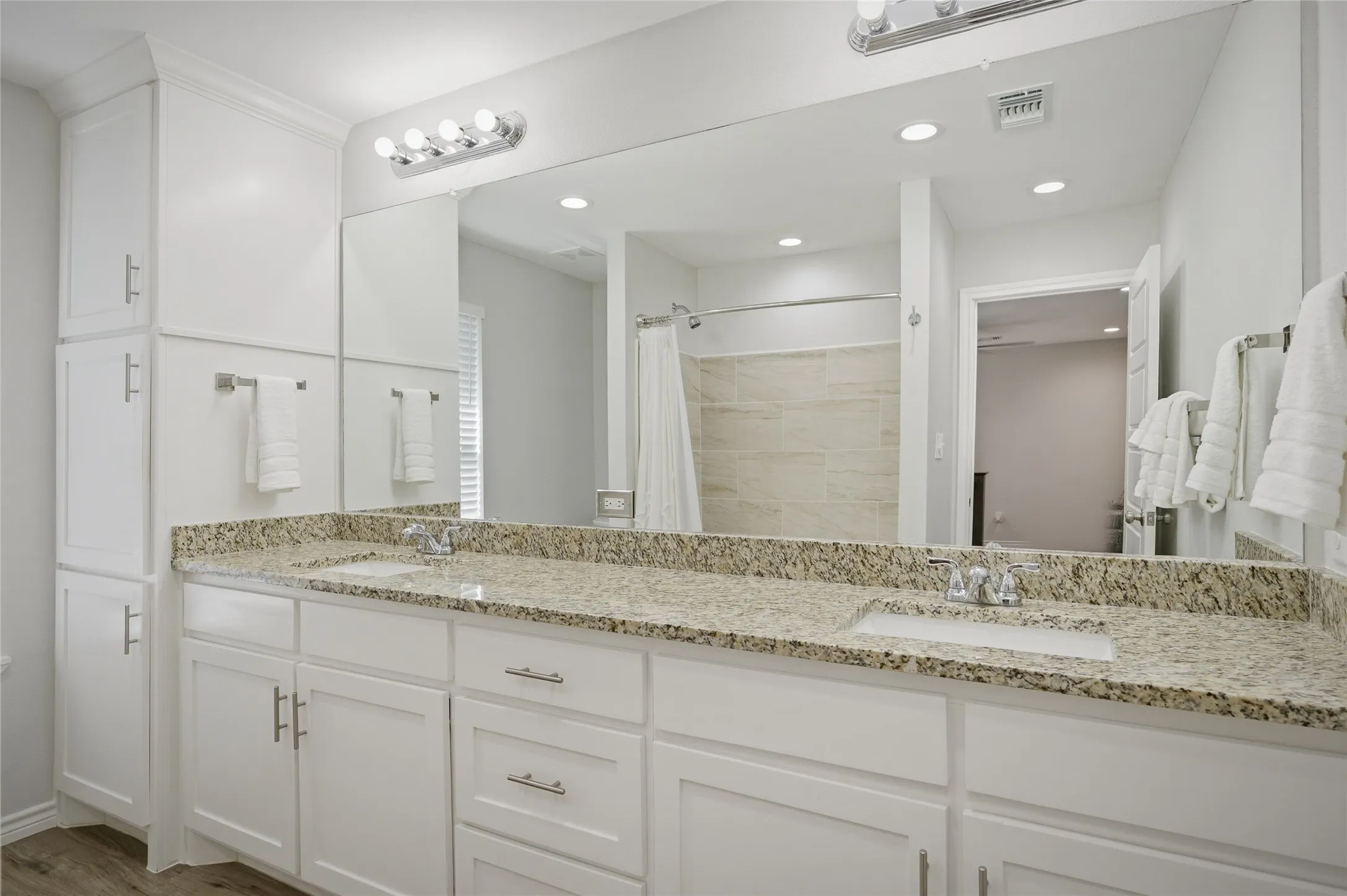 Dual sinks, granite countertops and lots of storage in the primary ensuite bathroom.