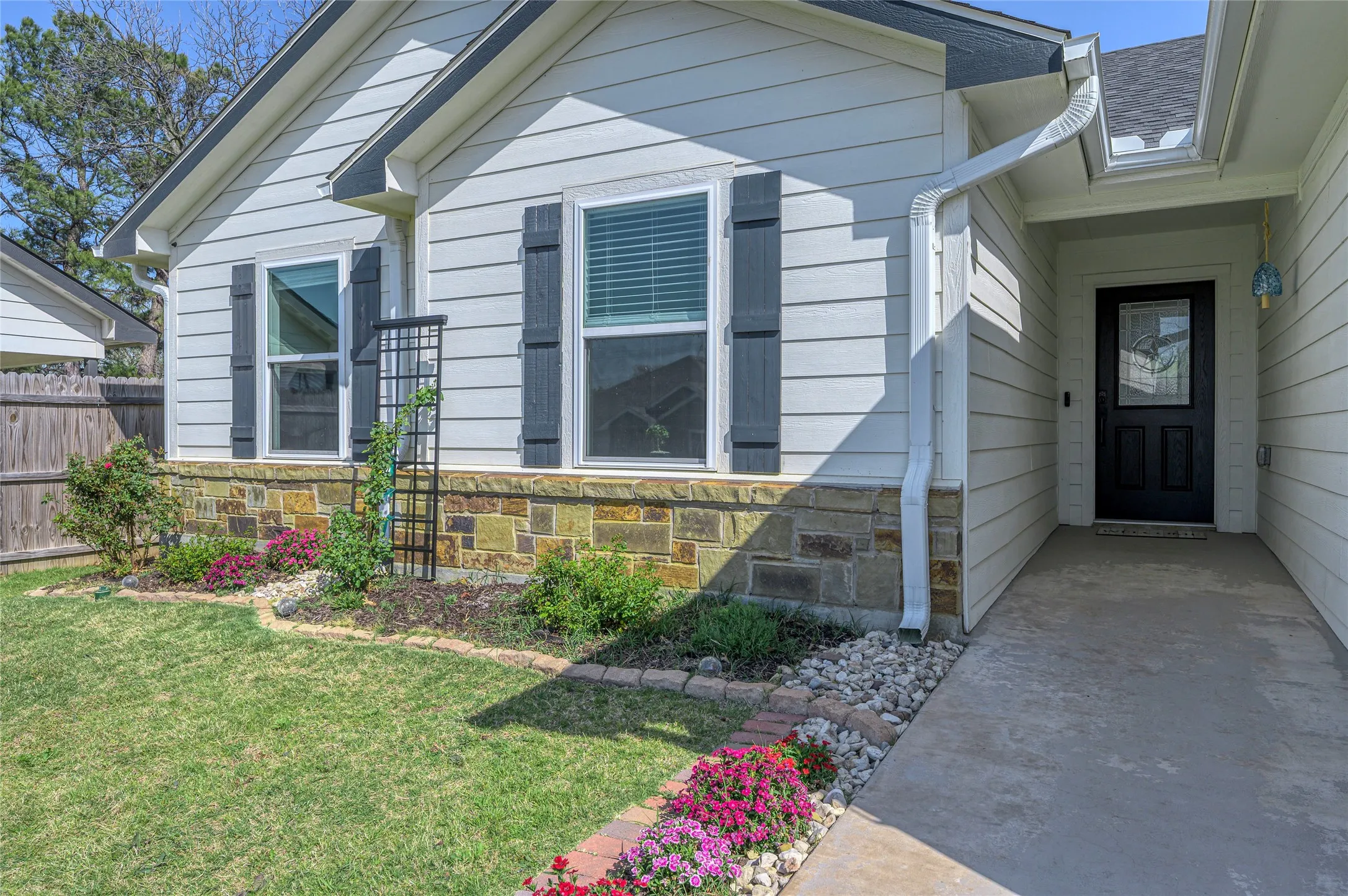 Private, covered entryway leading to a custom Texas Star front door.