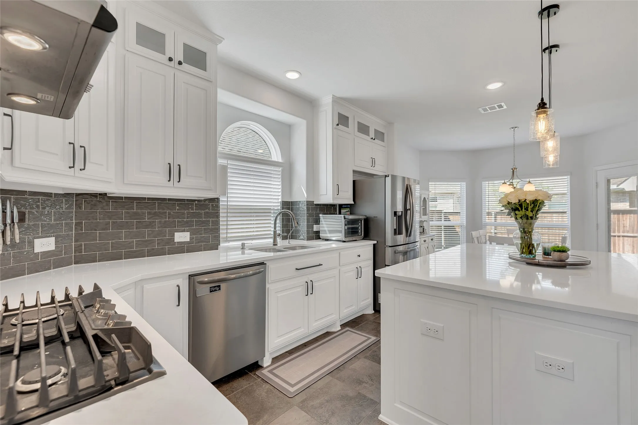 Has cooktop with modern accents on the backsplash and carried floors throughout main areas on first floor.