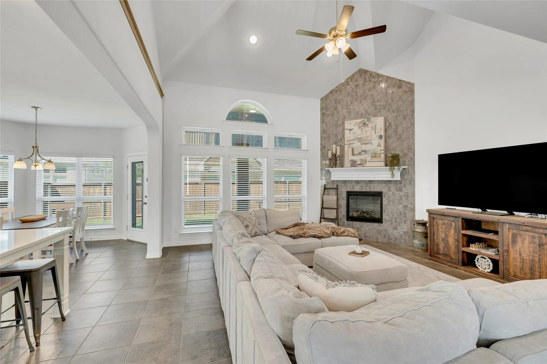 Open concept with vaulted ceilings. The kitchen overlooks the living and a beautiful tile surrounded fireplace.