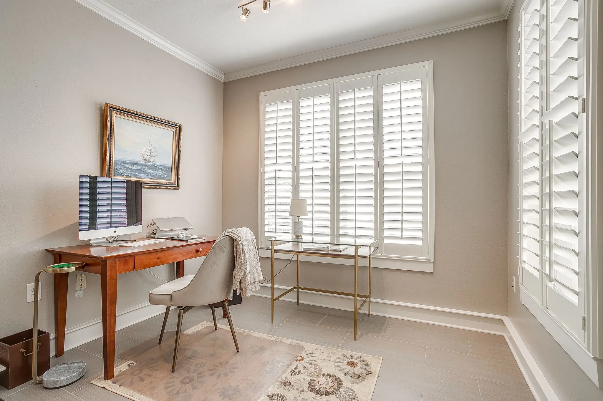 Office with ornamental molding and track lighting