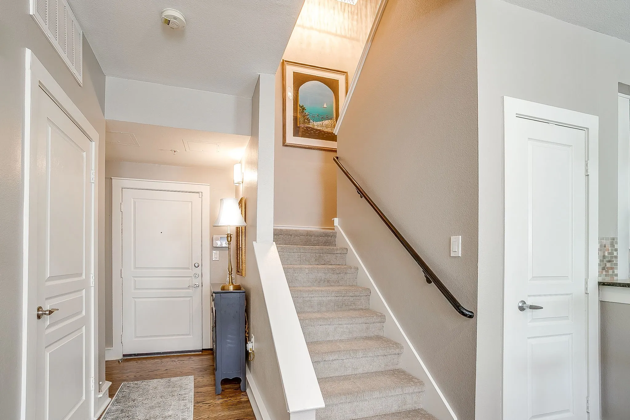 Stairway featuring wood finished floors