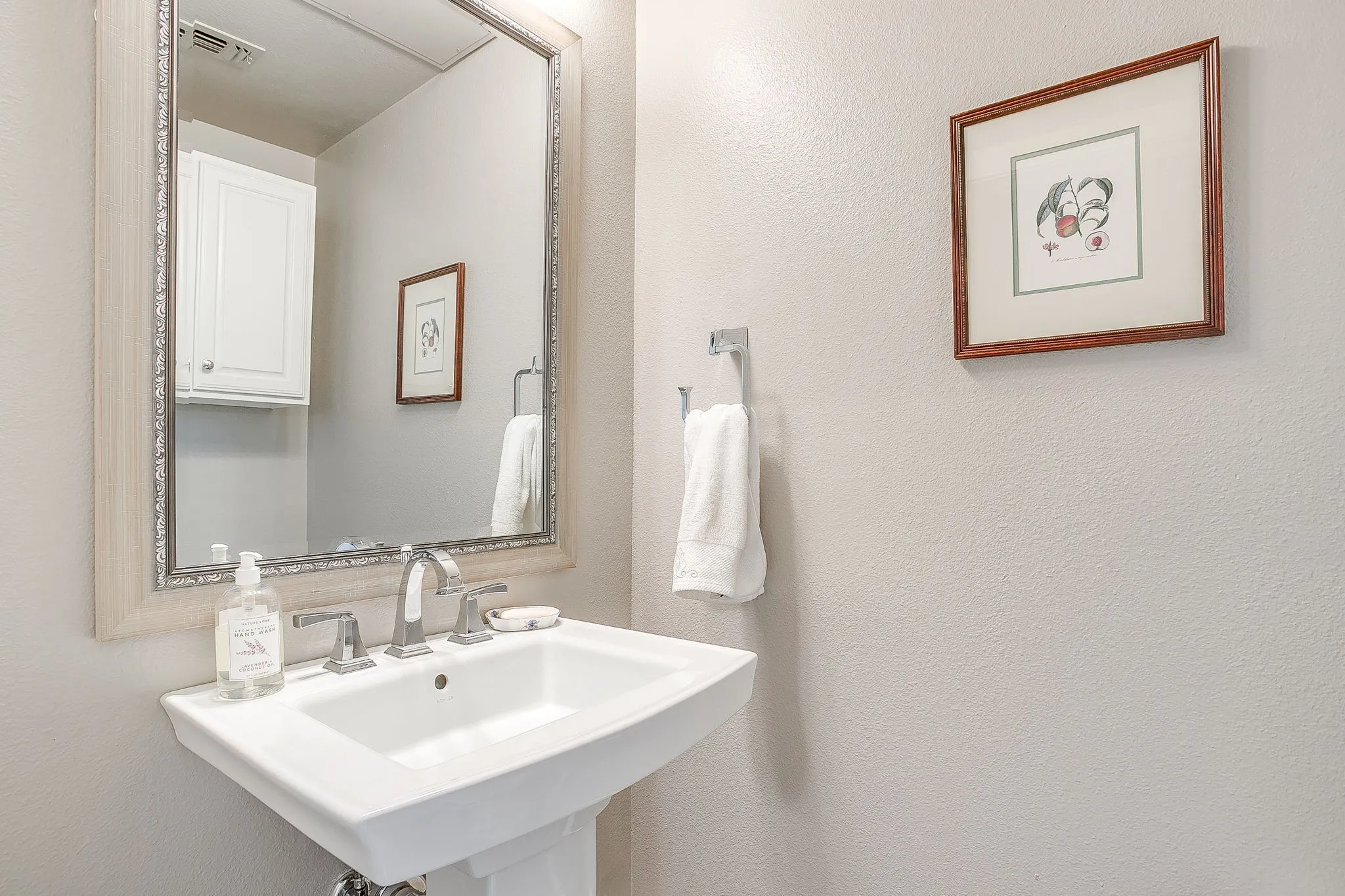 Bathroom featuring a sink and a textured wall