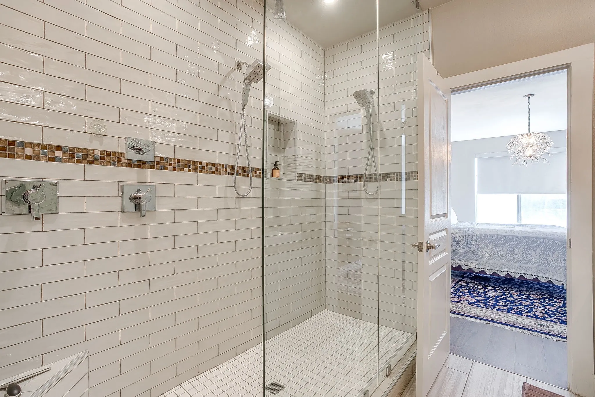 Ensuite bathroom featuring a stall shower and suspended lighting
