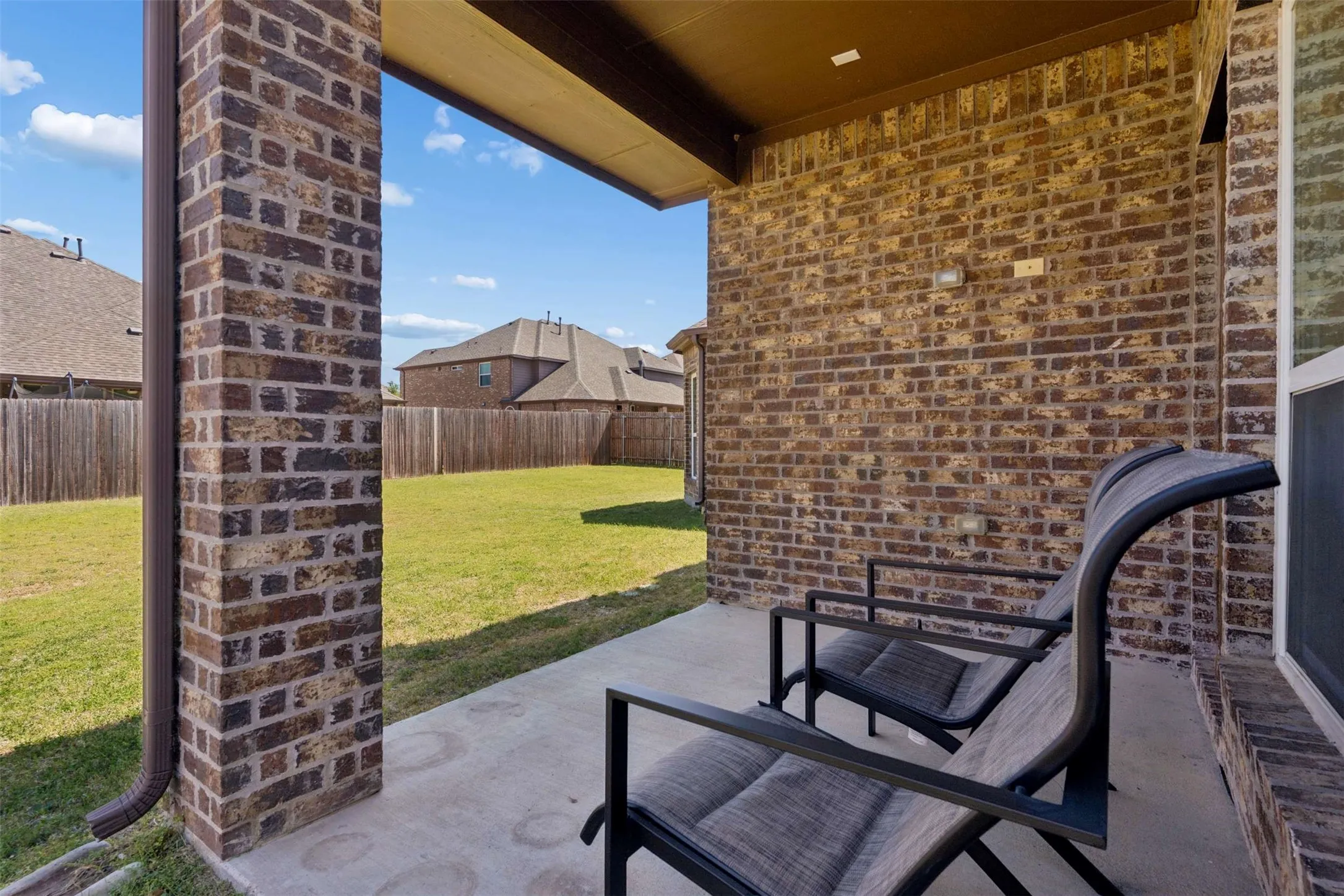 Fenced backyard with a patio area
