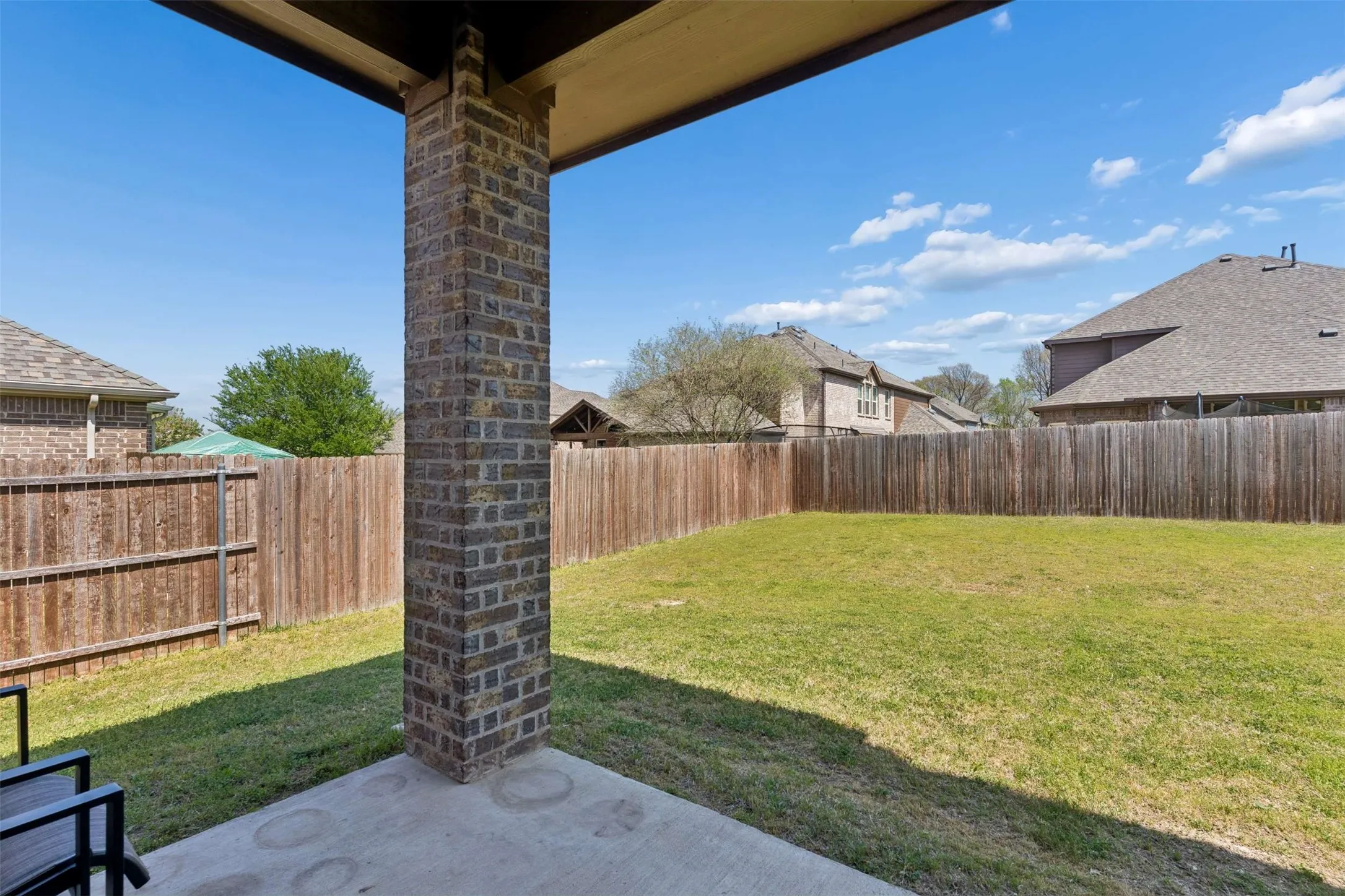 Fenced backyard with a patio