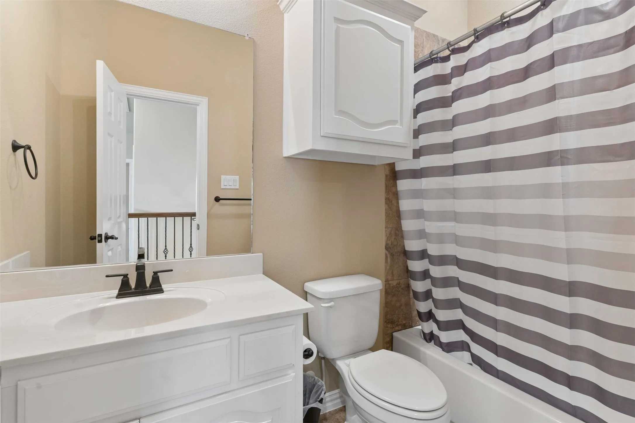Bathroom featuring vanity and shower / bath combo with shower curtain