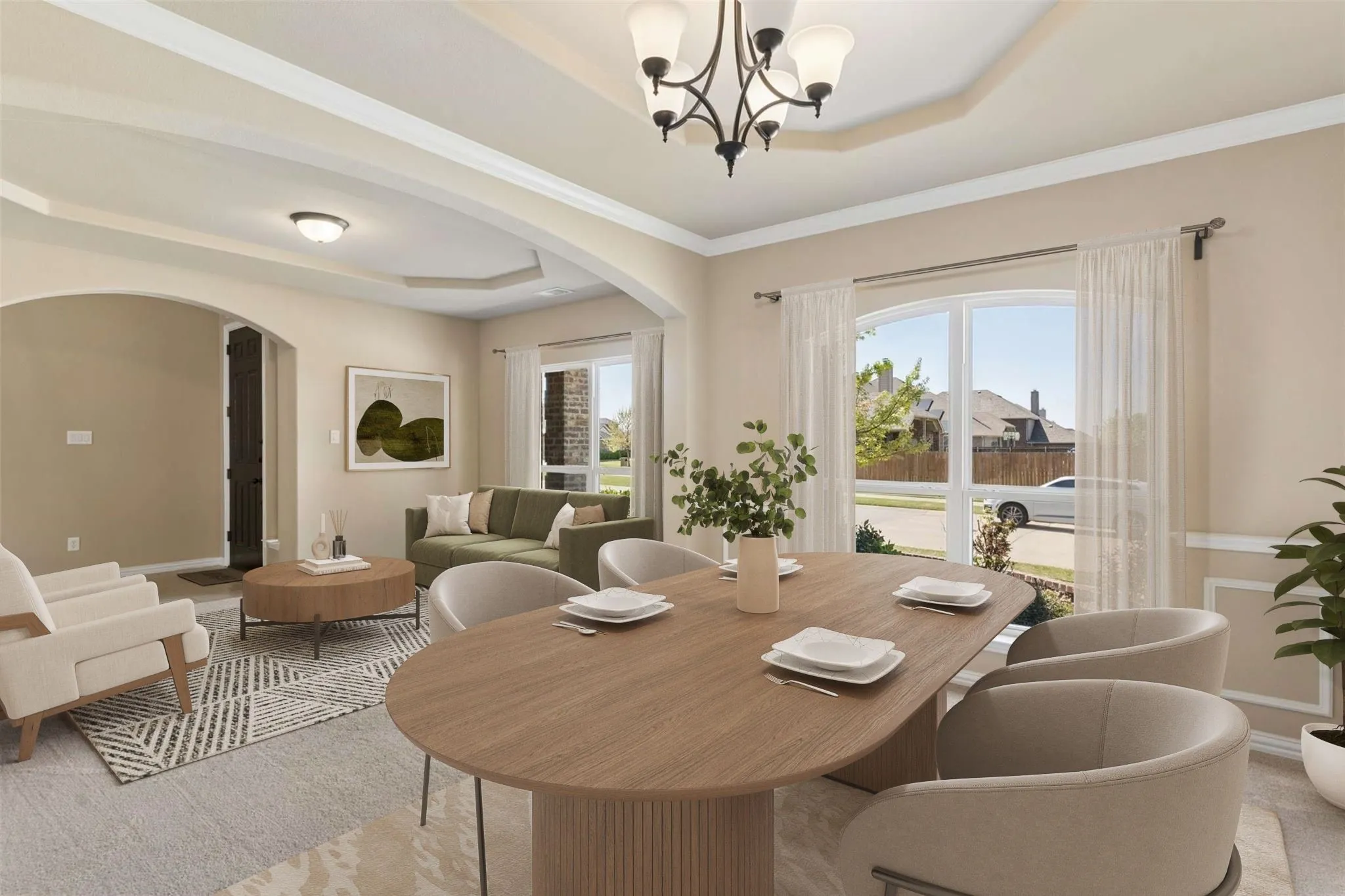 Formal dining area with tray ceiling and chandelier