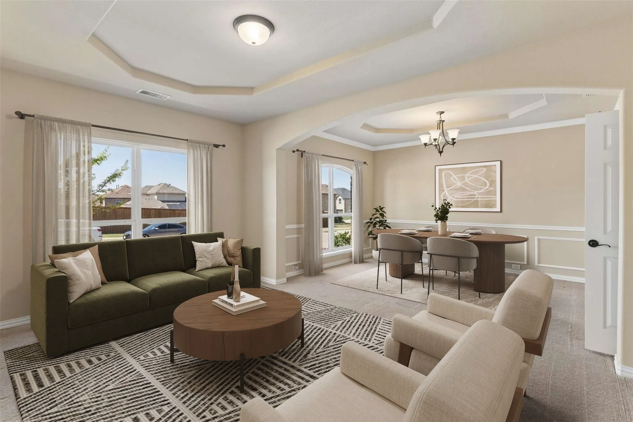 Tray ceilings in both living and dining areas, large windows with natural light, arched entryways, crown molding, and wainscoting details
