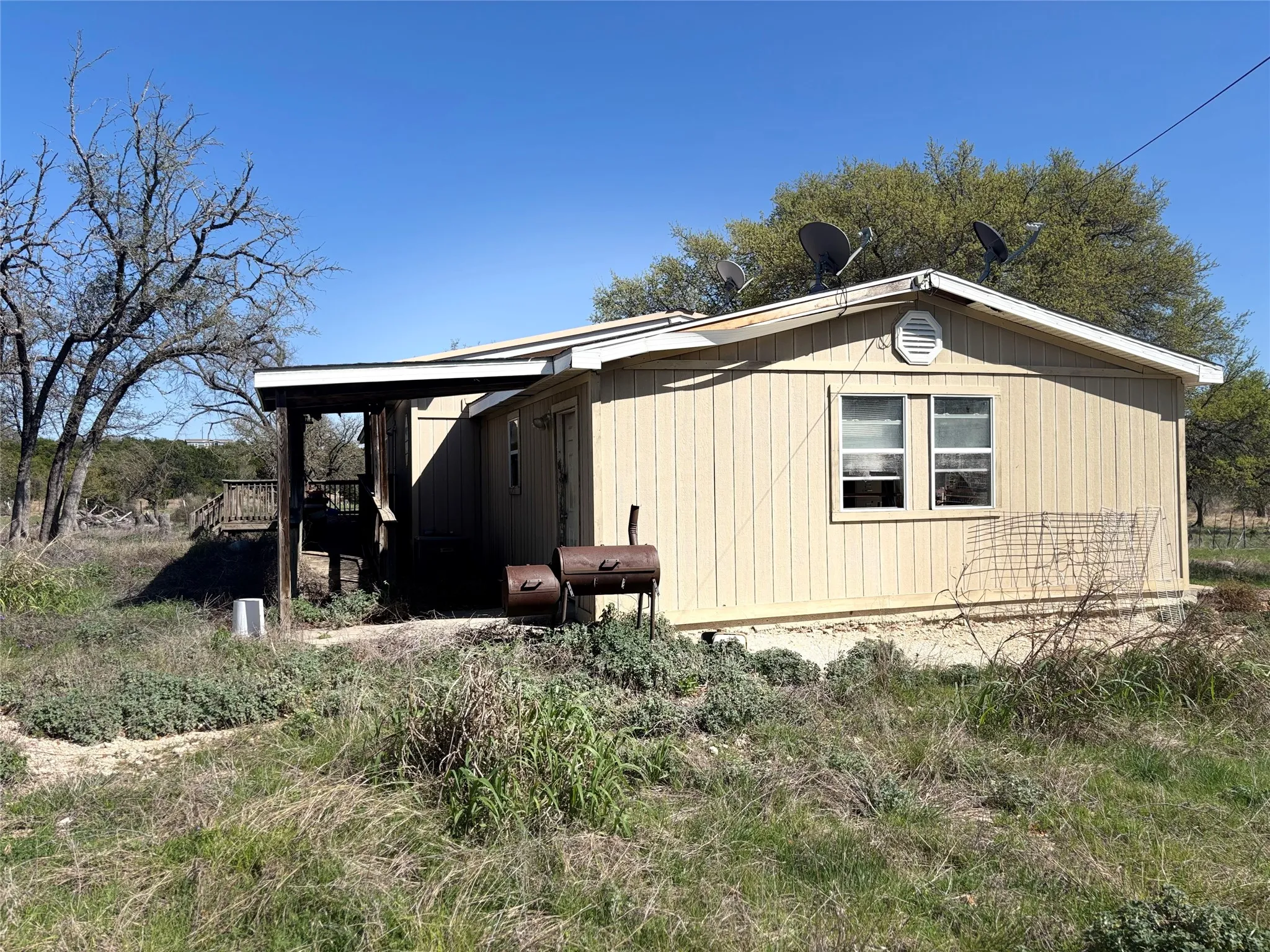 View of property exterior with a wooden deck