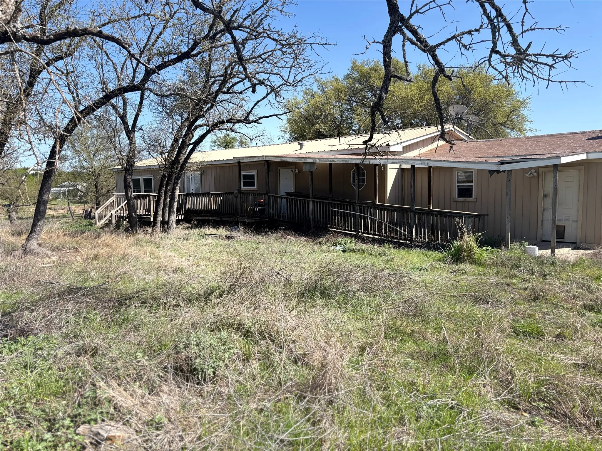 Rear view of house with a deck and board and batten siding