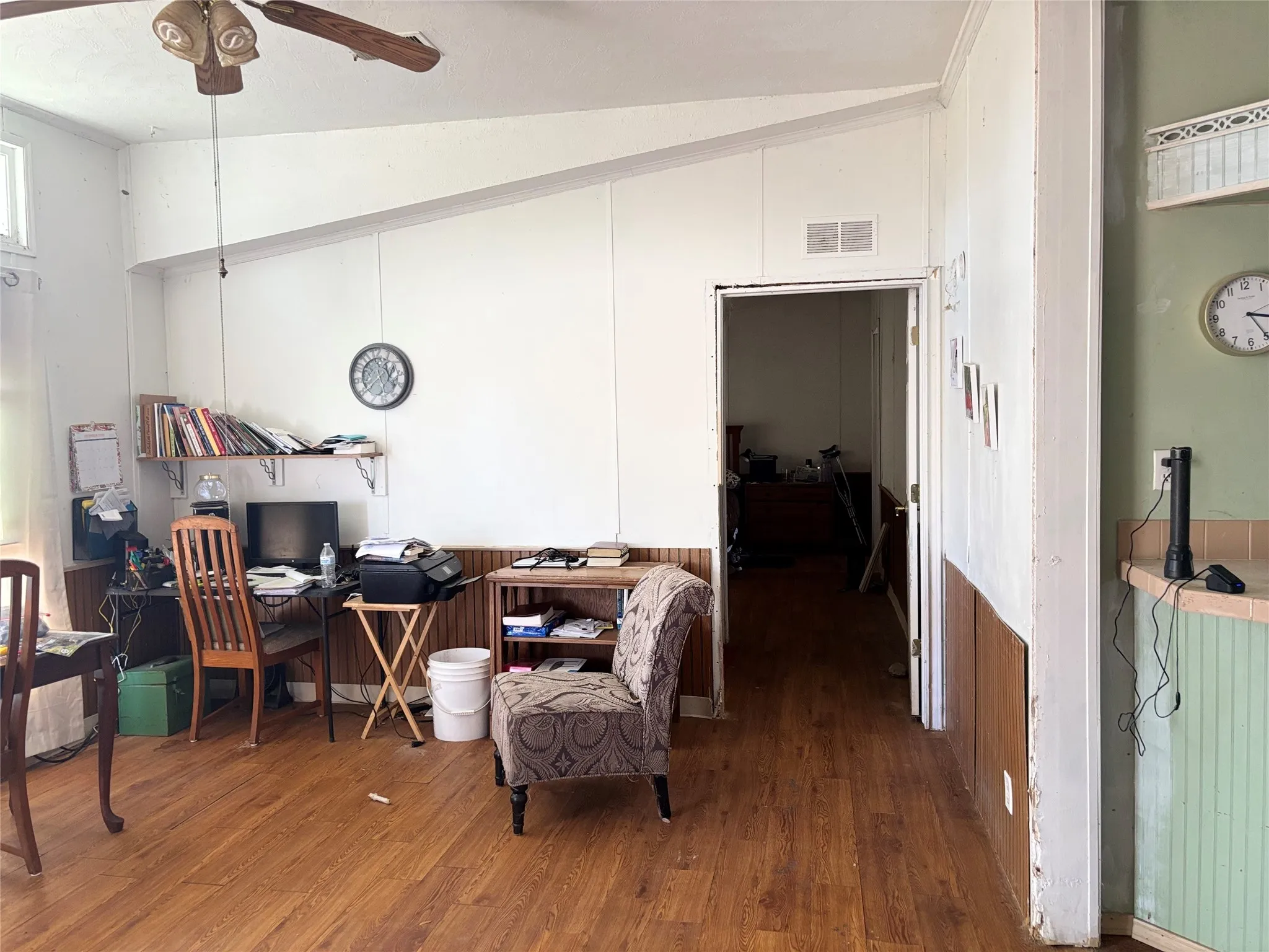 Office featuring vaulted ceiling, dark wood finished floors, and a ceiling fan