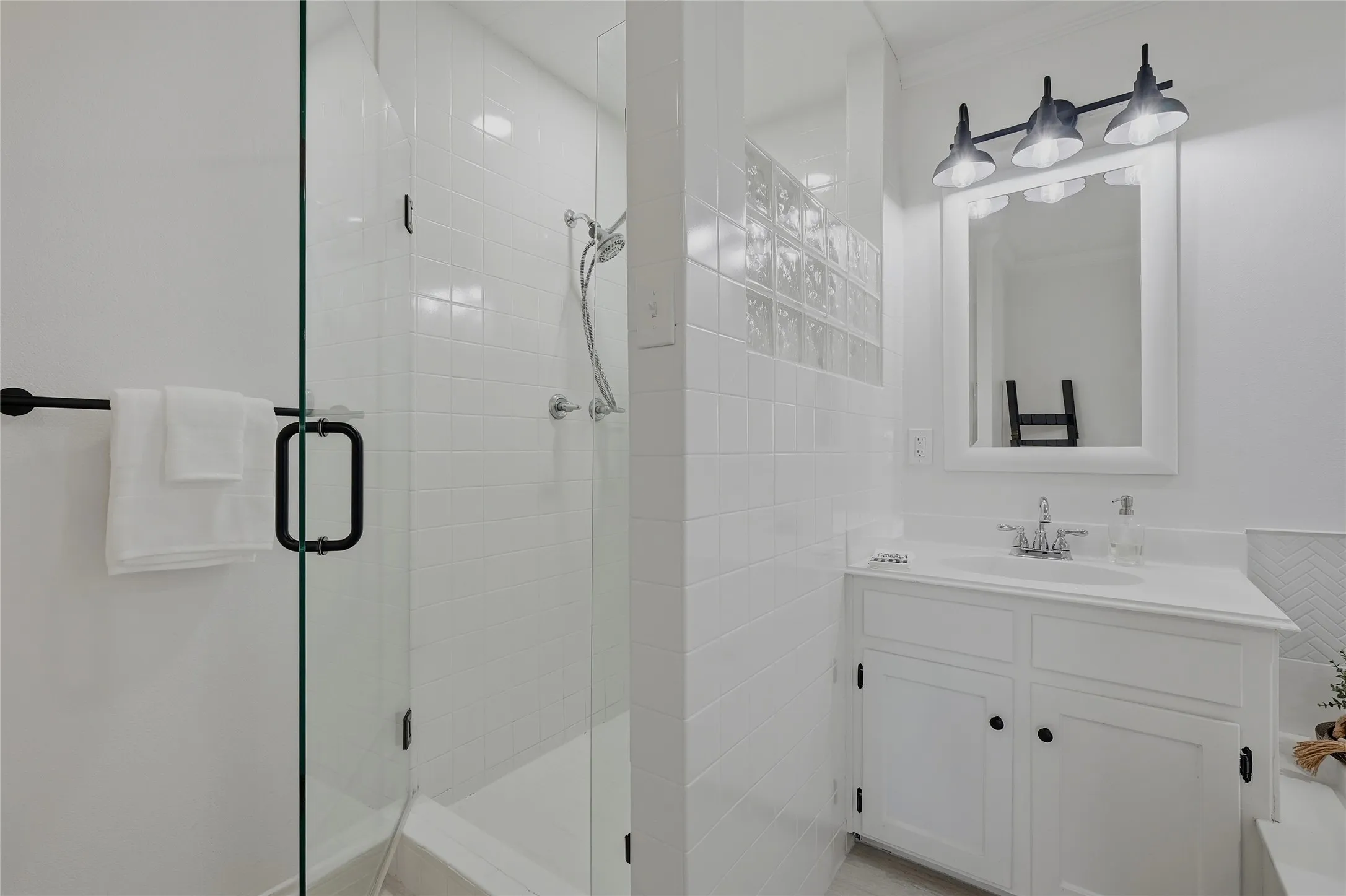 Full bath with vanity and a shower stall