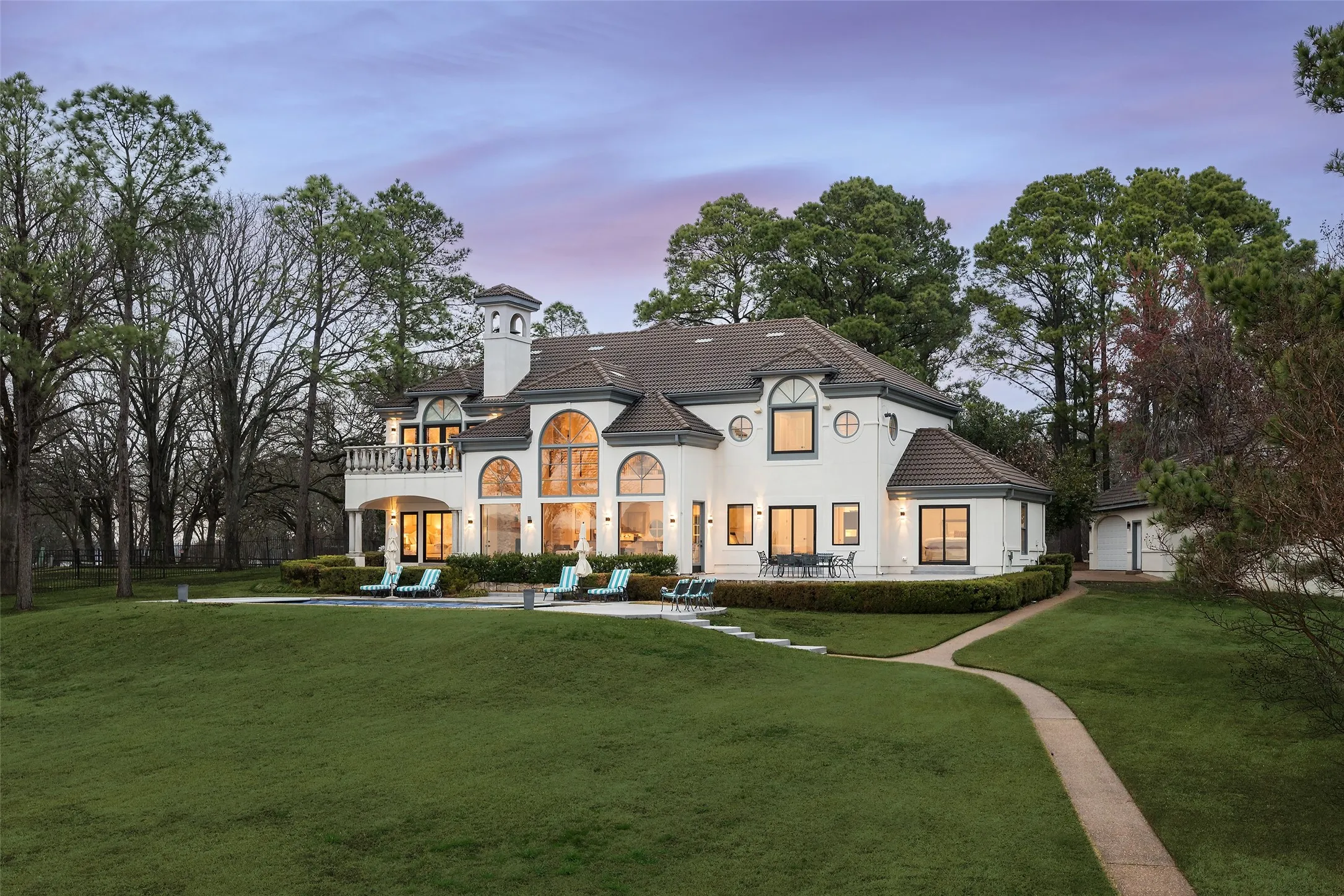 Lawn beyond pool with path to boathouse