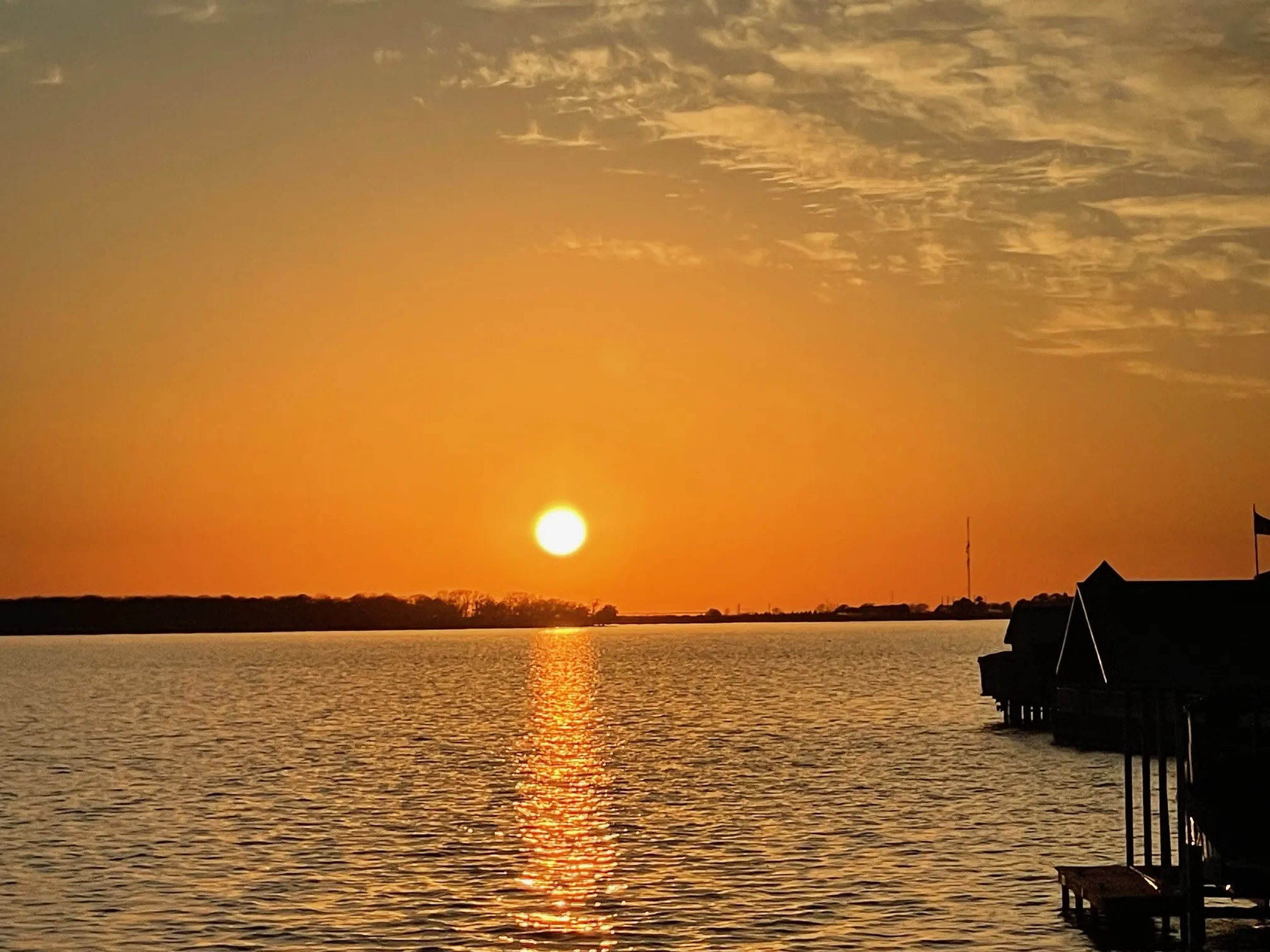 View of water at sunset from boathouse sundeck