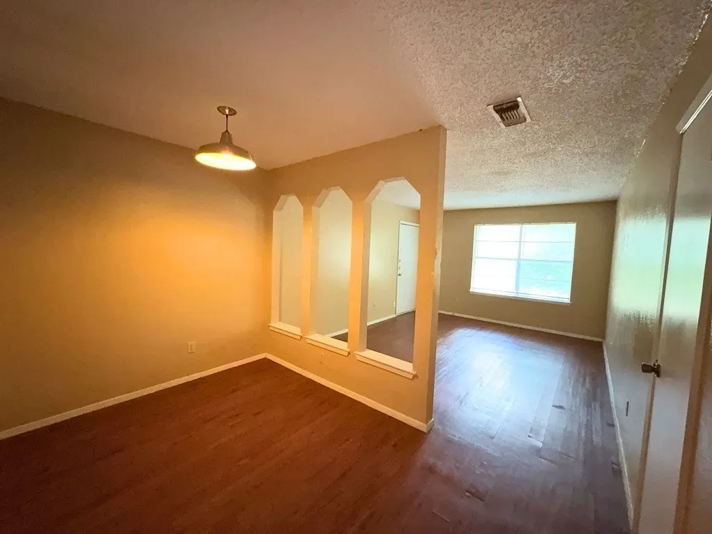 Dining area and living room connected by arched openings
