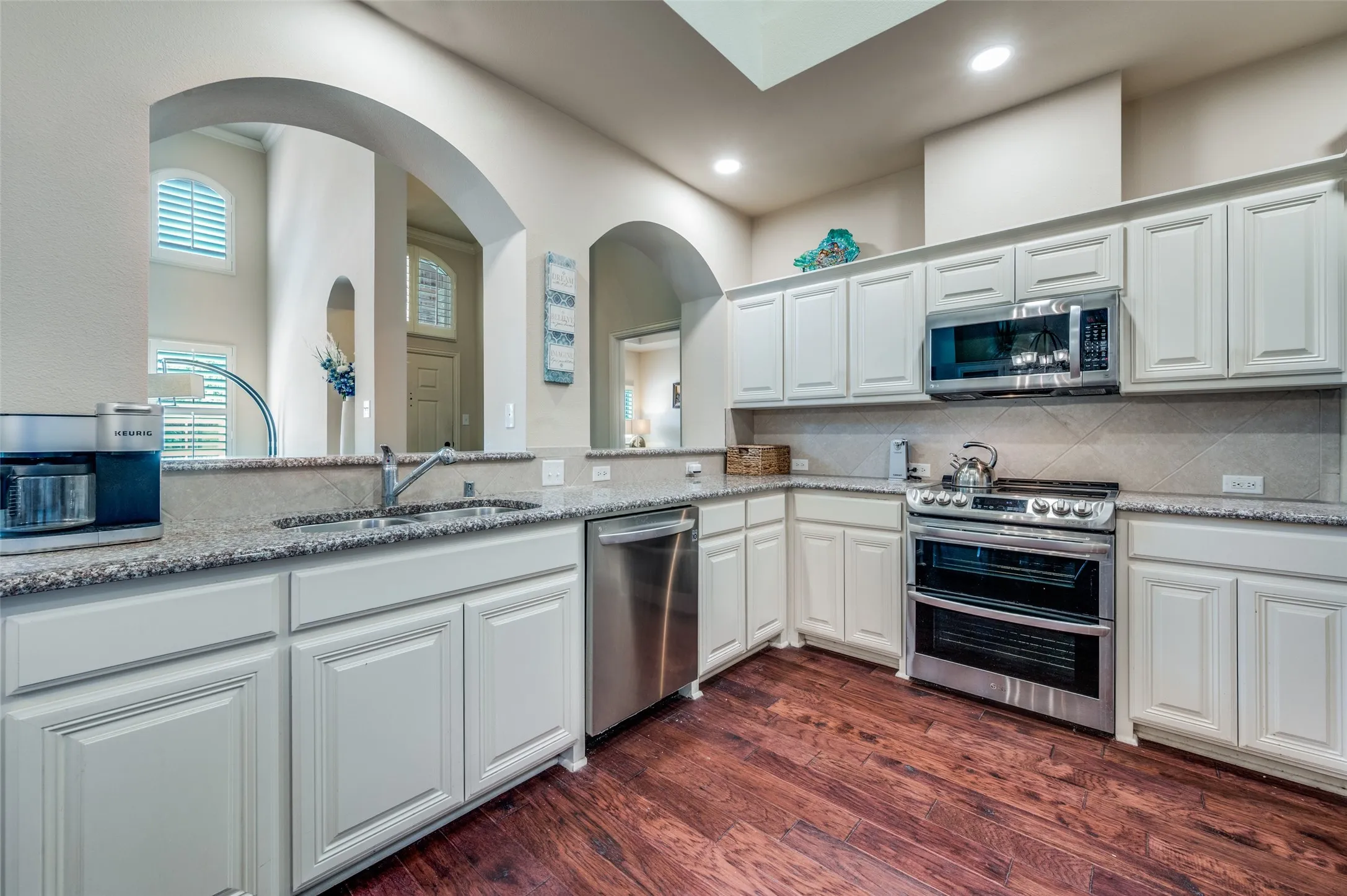 Spacious remodeled eat-in kitchen with abundant cabinet space, stainless steel appliances.
