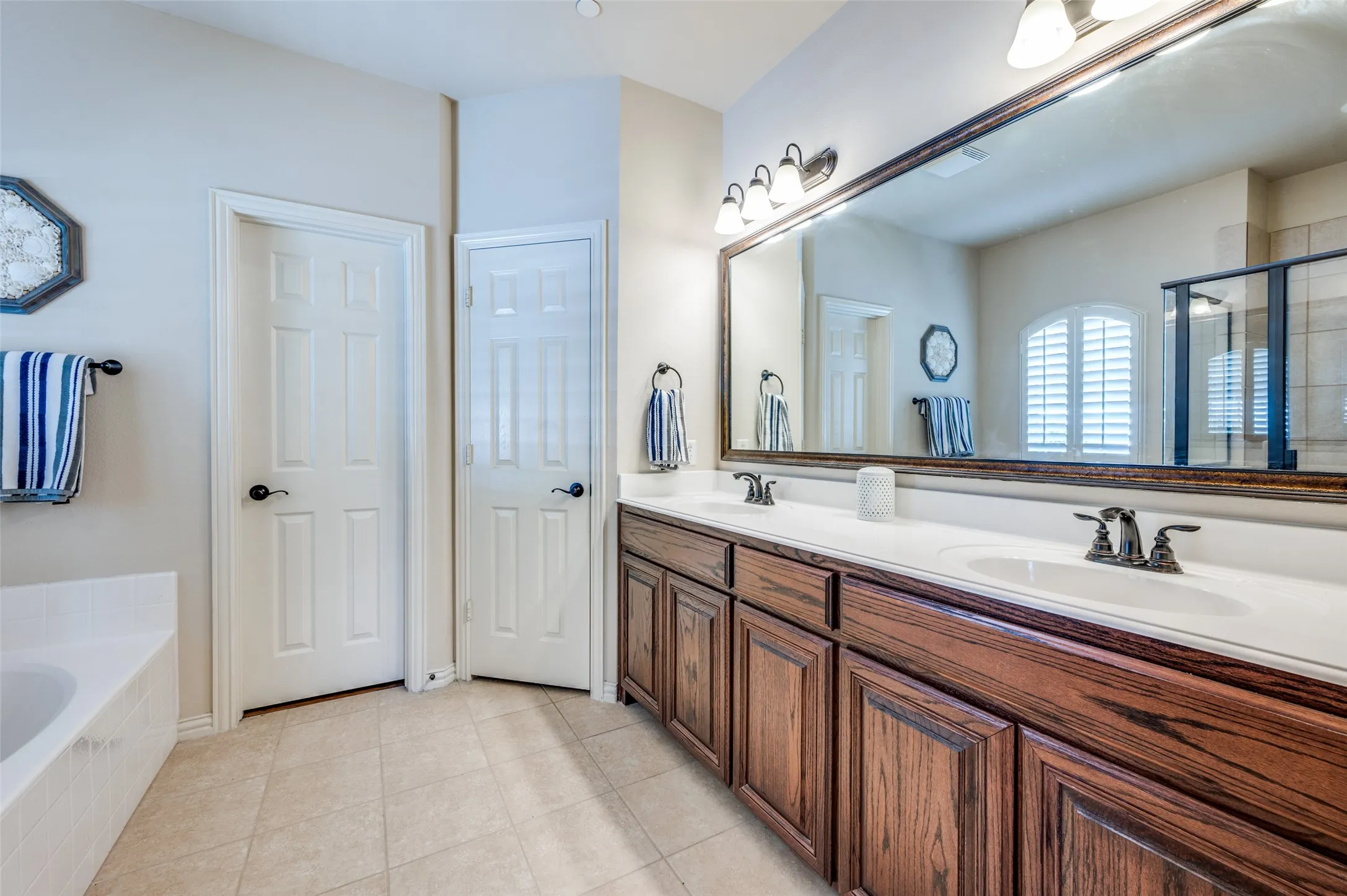 Dual sinks, built in cabinets, walk in closet with built in shelves.