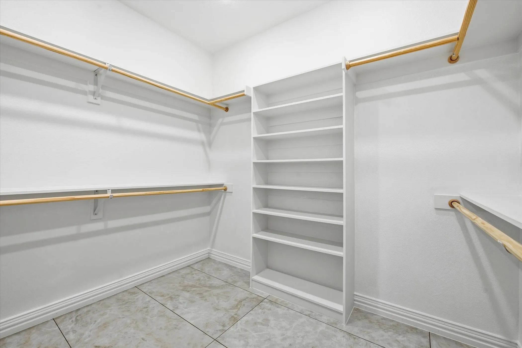 Walk in closet featuring light tile patterned flooring