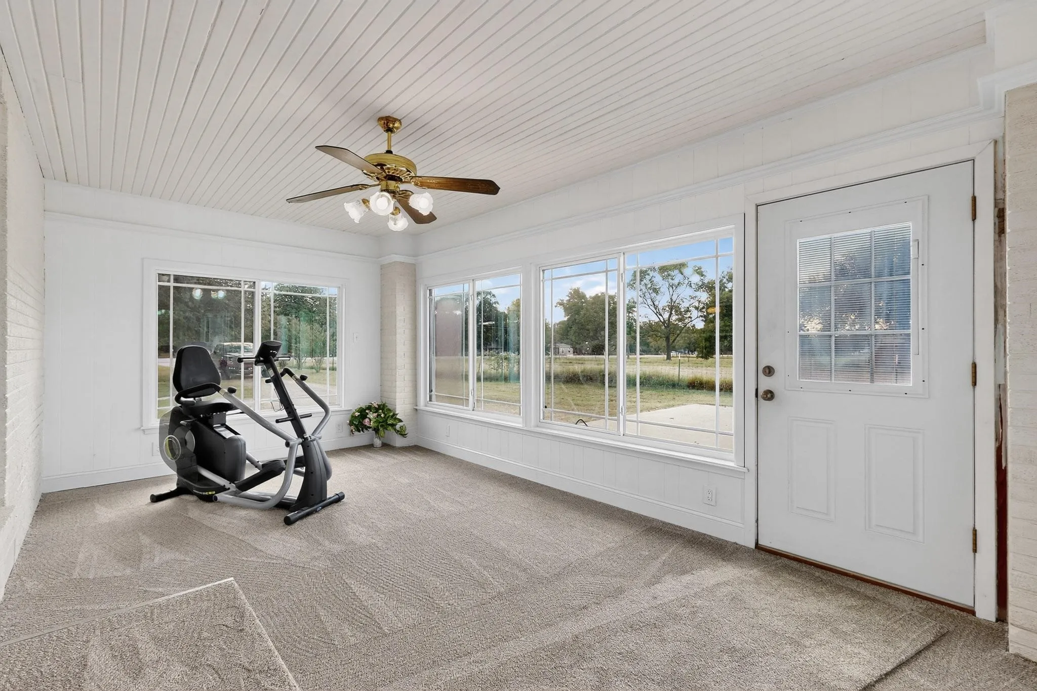Workout room with carpet, ceiling fan, and wood ceiling