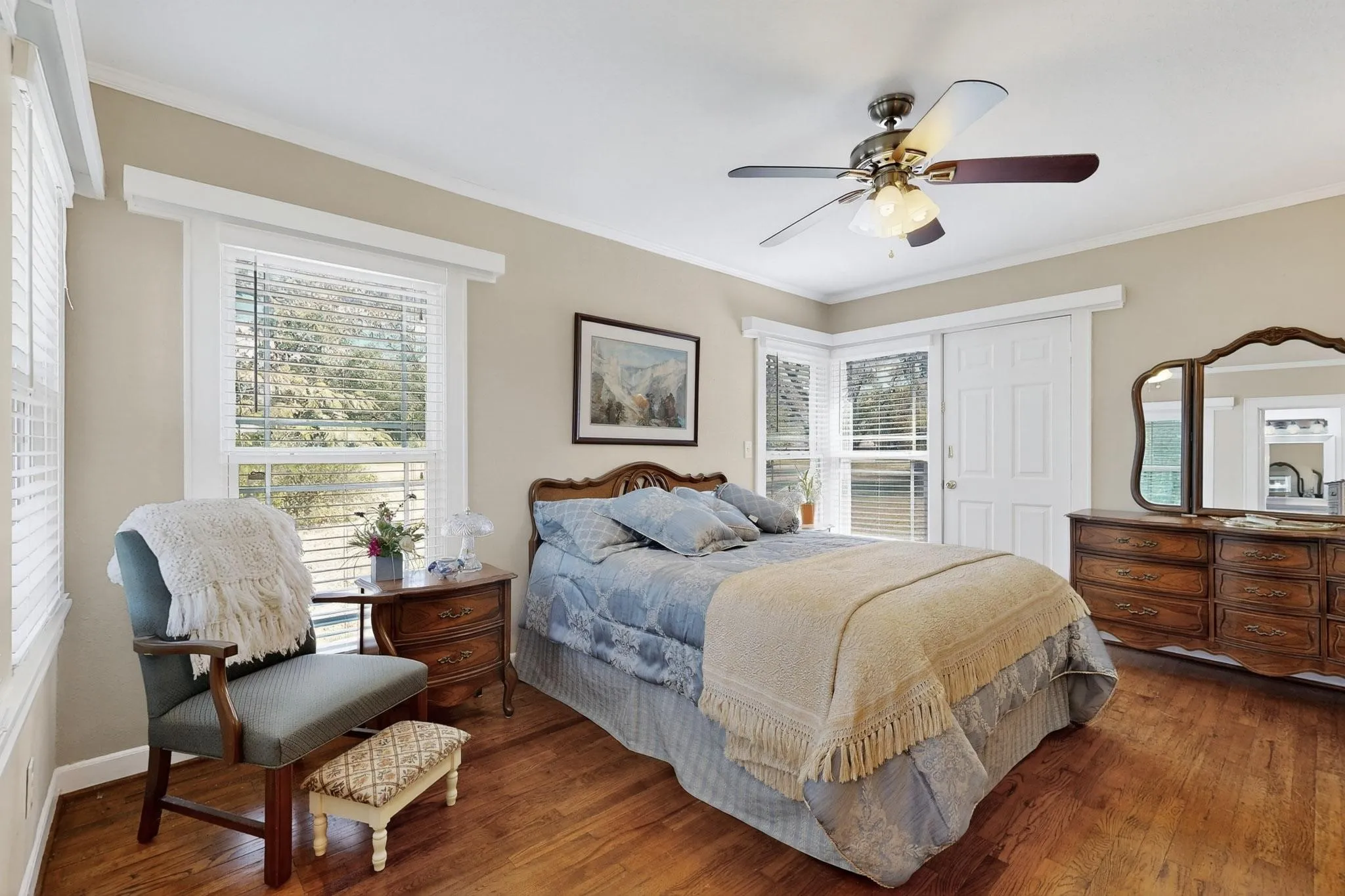 Bedroom featuring ornamental molding, wood finished floors, and ceiling fan