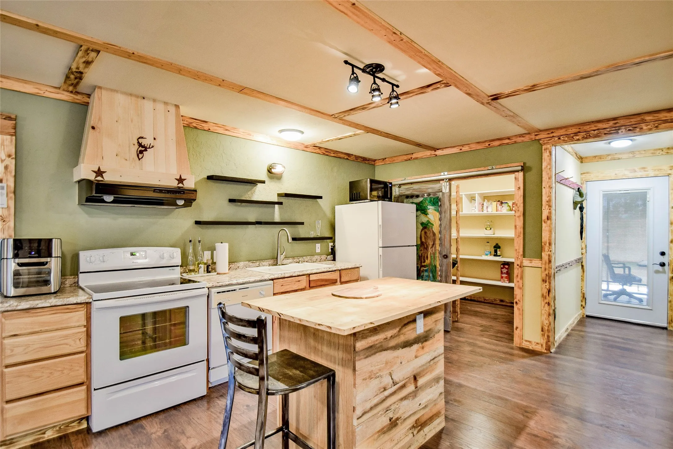 Aesthetically pleasing color palette graces this all natural wood kitchen.