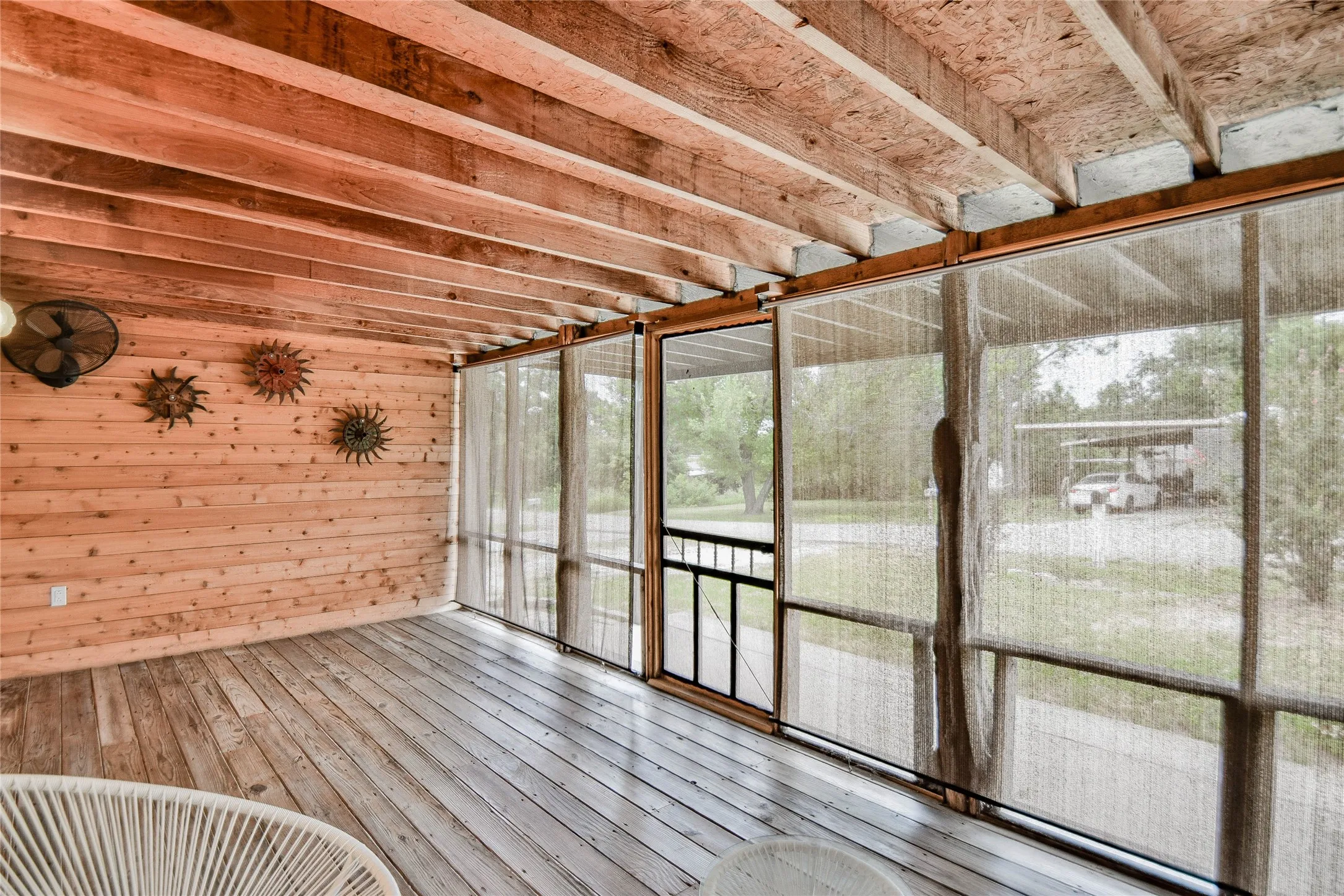 View of front enclosed deck with blings and beautiful knotty pine walls.