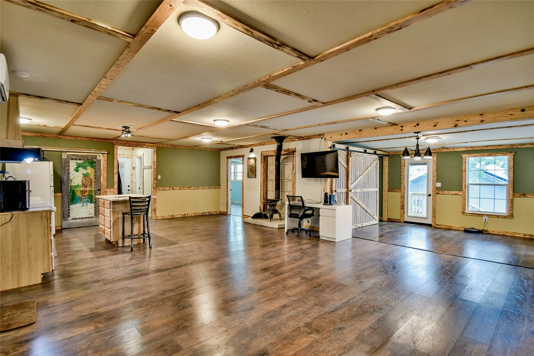 Impressive living area with two living areas, great kitchen space and dining room with great freestanding wood-burning fireplace.