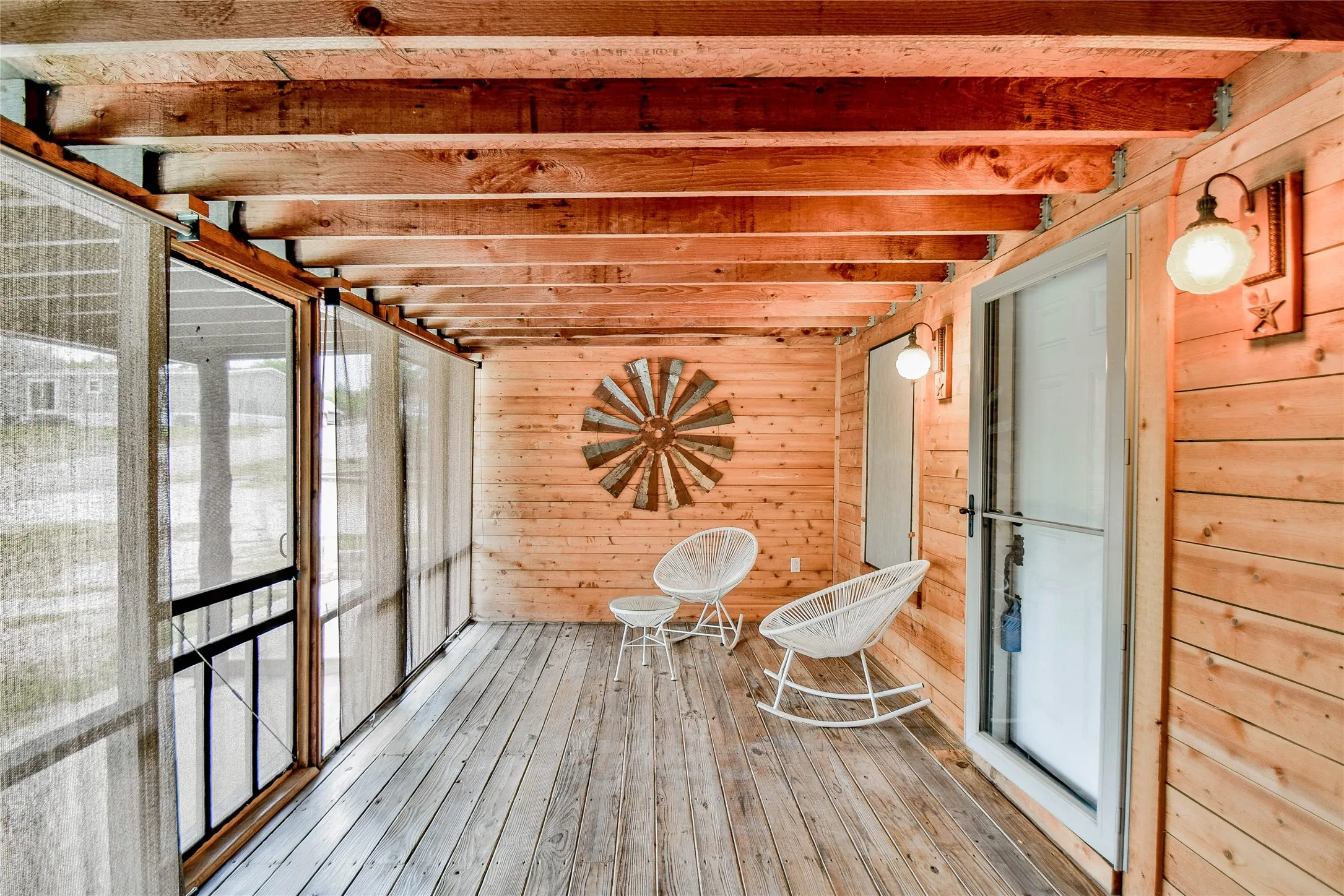 Front enclosed deck with wood flooring and pull-down blinds - great place to relax!