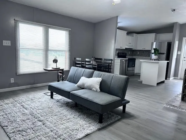 Open-concept living area featuring light wood-finish flooring