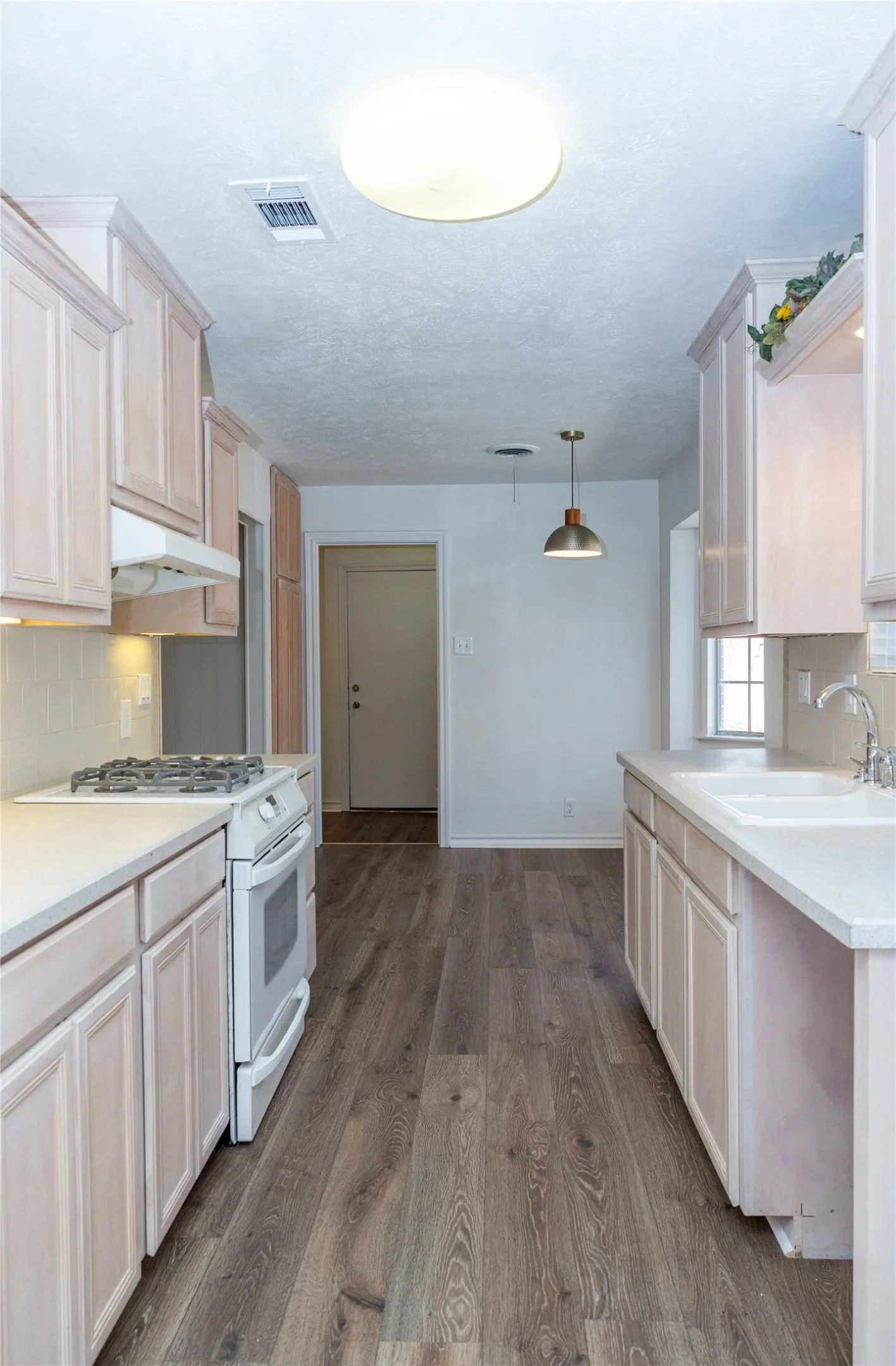 Lots of storage in the kitchen with gas range and eating area.