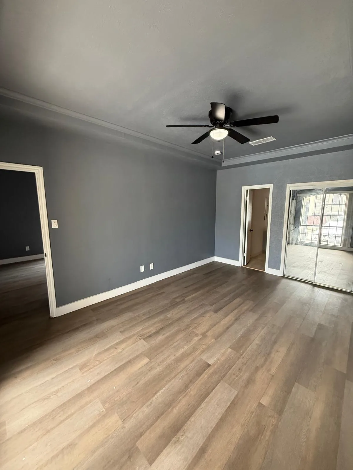 Unfurnished bedroom featuring a ceiling fan, light wood-type flooring, and a closet