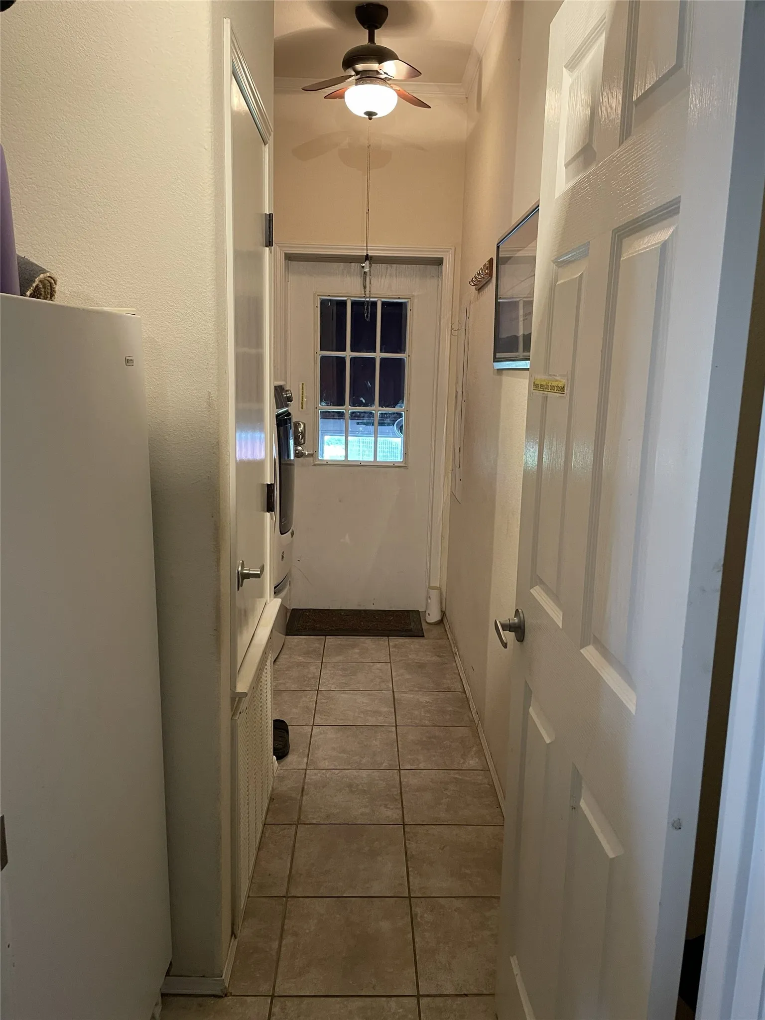 Laundry/mud room has cabinets for storeage, a drying rack & room for a stand up freezer